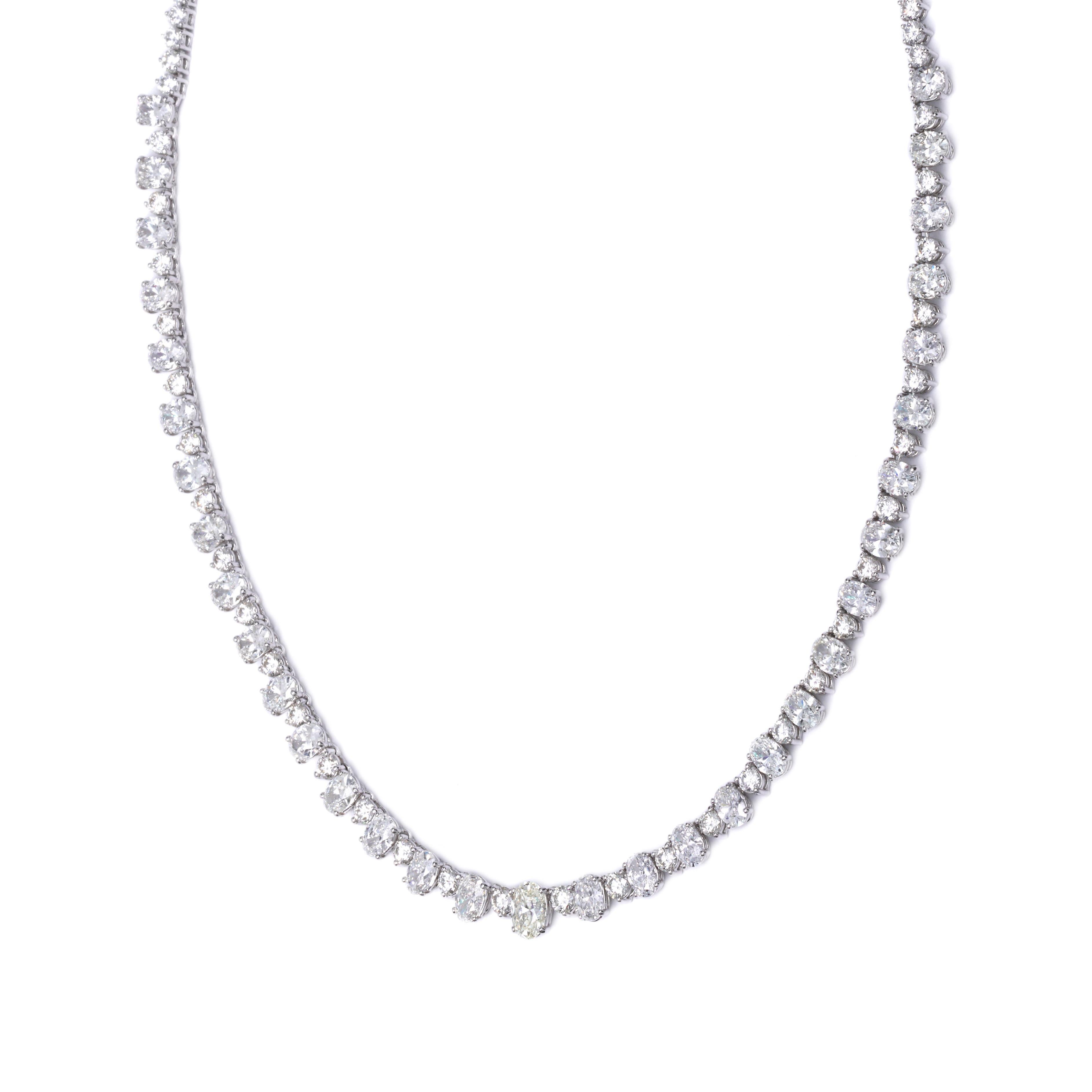This necklace is 17 inches in length, made of 18K white gold. It contains oval G-color, VS2-SI1 clarity diamonds weighing 10.62 CTTW, round G-color and VS2-SI1 clarity diamonds weighing 5.69 CTTW.