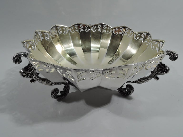 Fancy sterling silver bowl. Made by Shiebler in New York, ca 1890. Modern round and faceted form, and pierced and stylized ornamental border. Interior gilt washed with engraved interlaced script monogram in well. Engraved to underside is date “Oct.