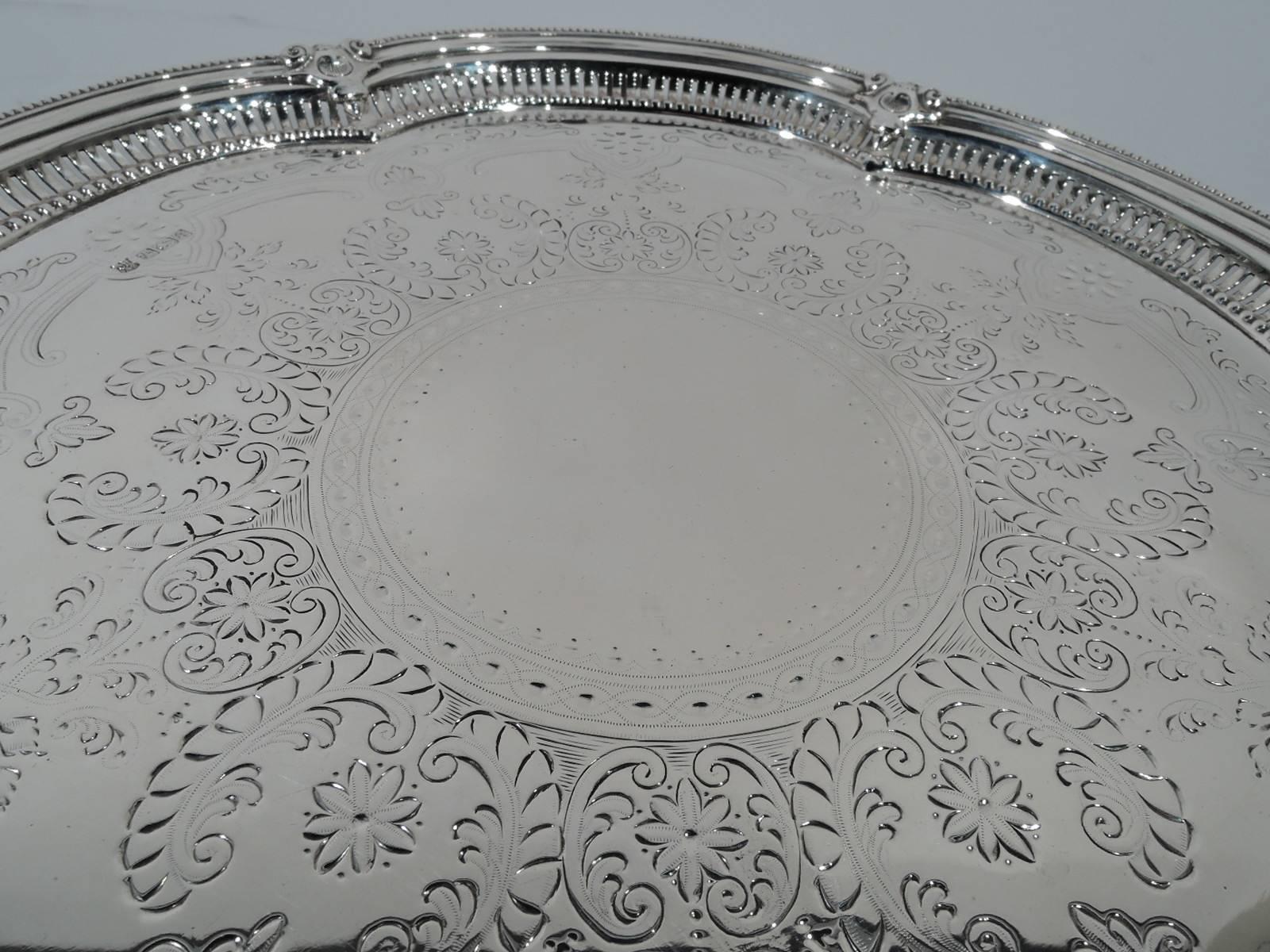 Edwardian sterling silver salver. Made by Cooper Bros & Sons in Sheffield in 1908. Circular and multi foil with shallow c-form lobes. Stylized ornament. Well has engraved ornament: beaded and guilloche central frame (vacant) surrounded by stylized