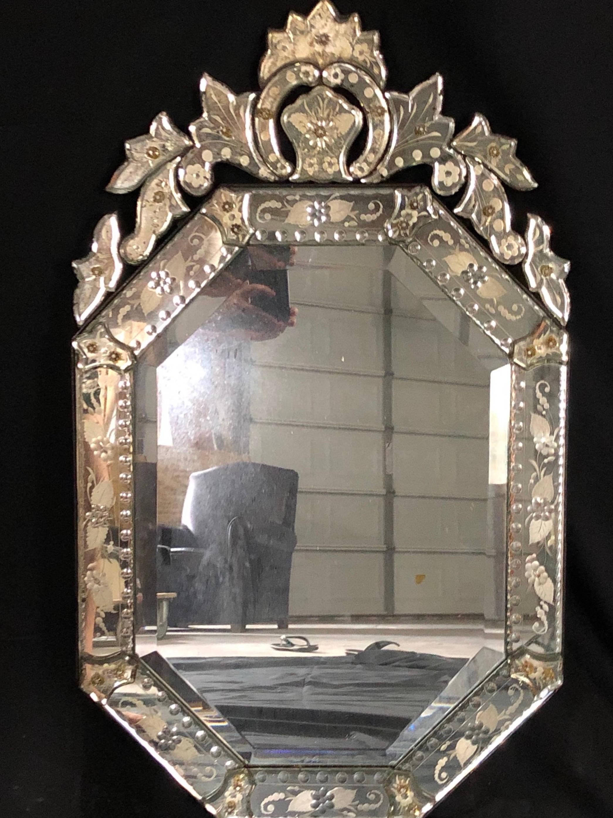 An intricate circa 1940s Venetian mirror with etched foliage and floral motif and with detailed crown. All intact and original glass! #5216.