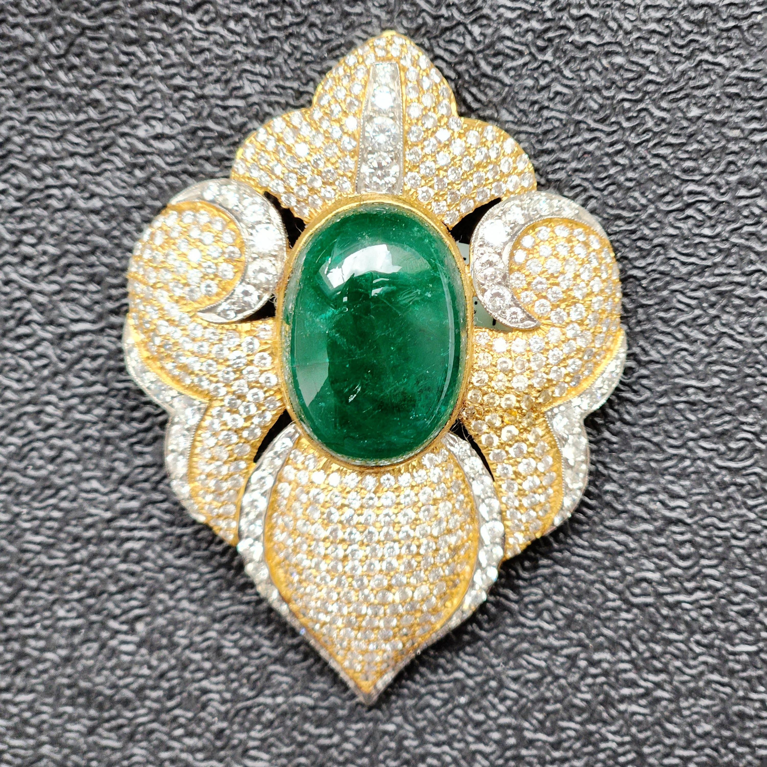Introducing the Fancy Art Deco Pendant Brooch, a stunning and unique piece of jewelry that showcases exquisite craftsmanship and impeccable design. The centerpiece of this piece is a dazzling green oval cabochon emerald (weighing 19.46 cts) that