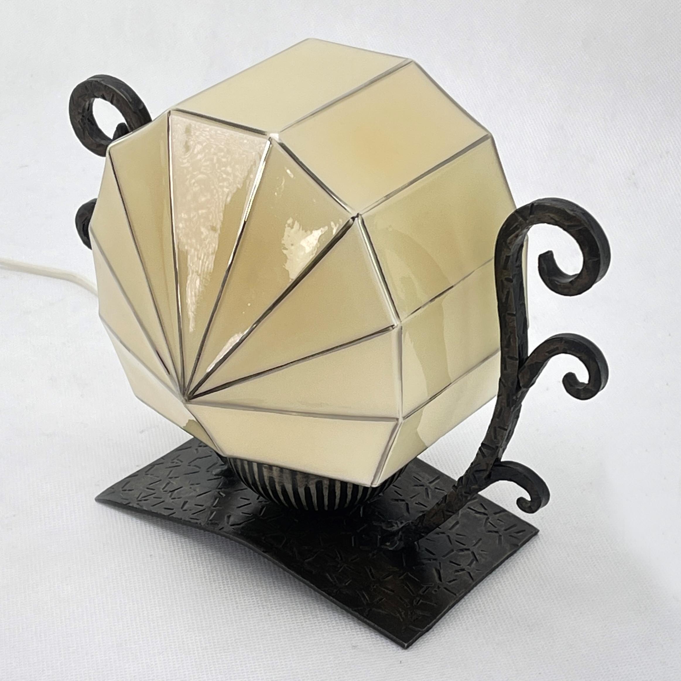 This original table lamp captivates with its simple and matter-of-fact Art Deco design. The decorative lamp gives a very pleasant light. This beautiful table lamp is an absolute design classic from the ART DECOS period. 

The lamp glass has a silver