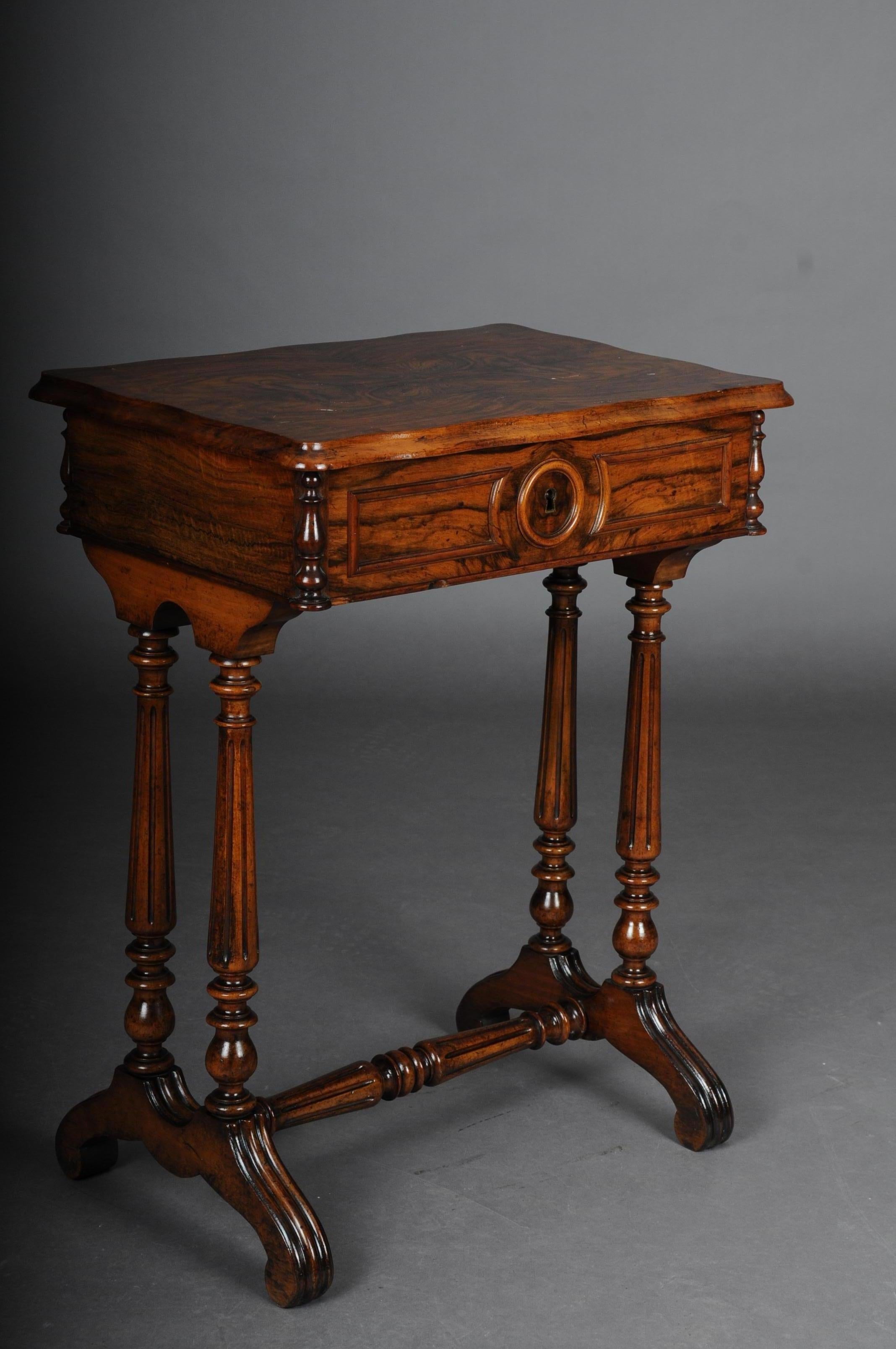 Fancy Biedermeier sewing table / side table circa 1850 walnut

Solid walnut body. Beautiful walnut mirror veneer. Frame case on four long, turned legs connected by a central bar. Hinged cover plate which is provided with a mirror (mirror has a