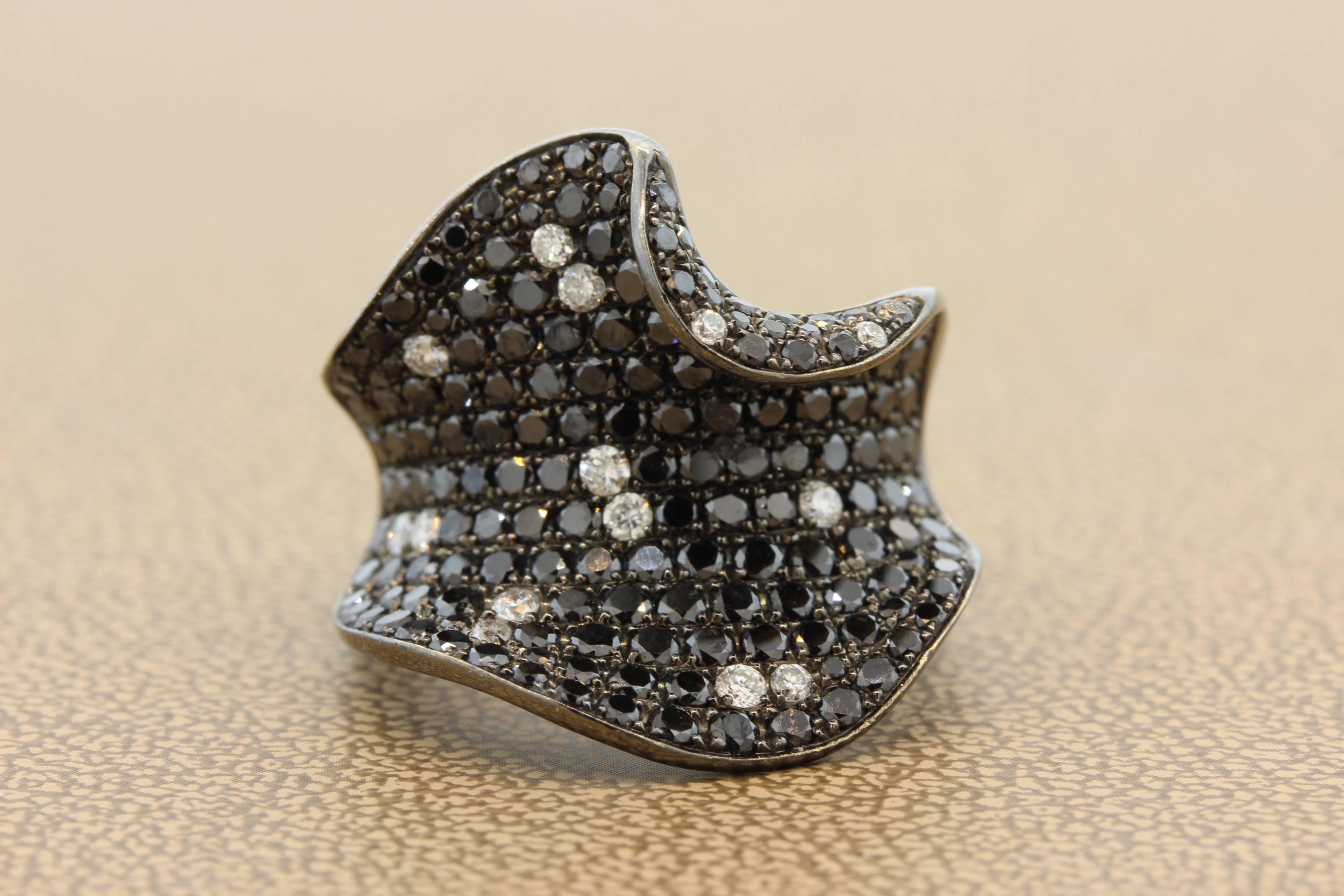 A fabulous design, this ring features 3.40 carats of black and white diamonds creating a fine contrast to the ring. Set in 18K gold, a ring for a special woman. 

Size 6 ¾
