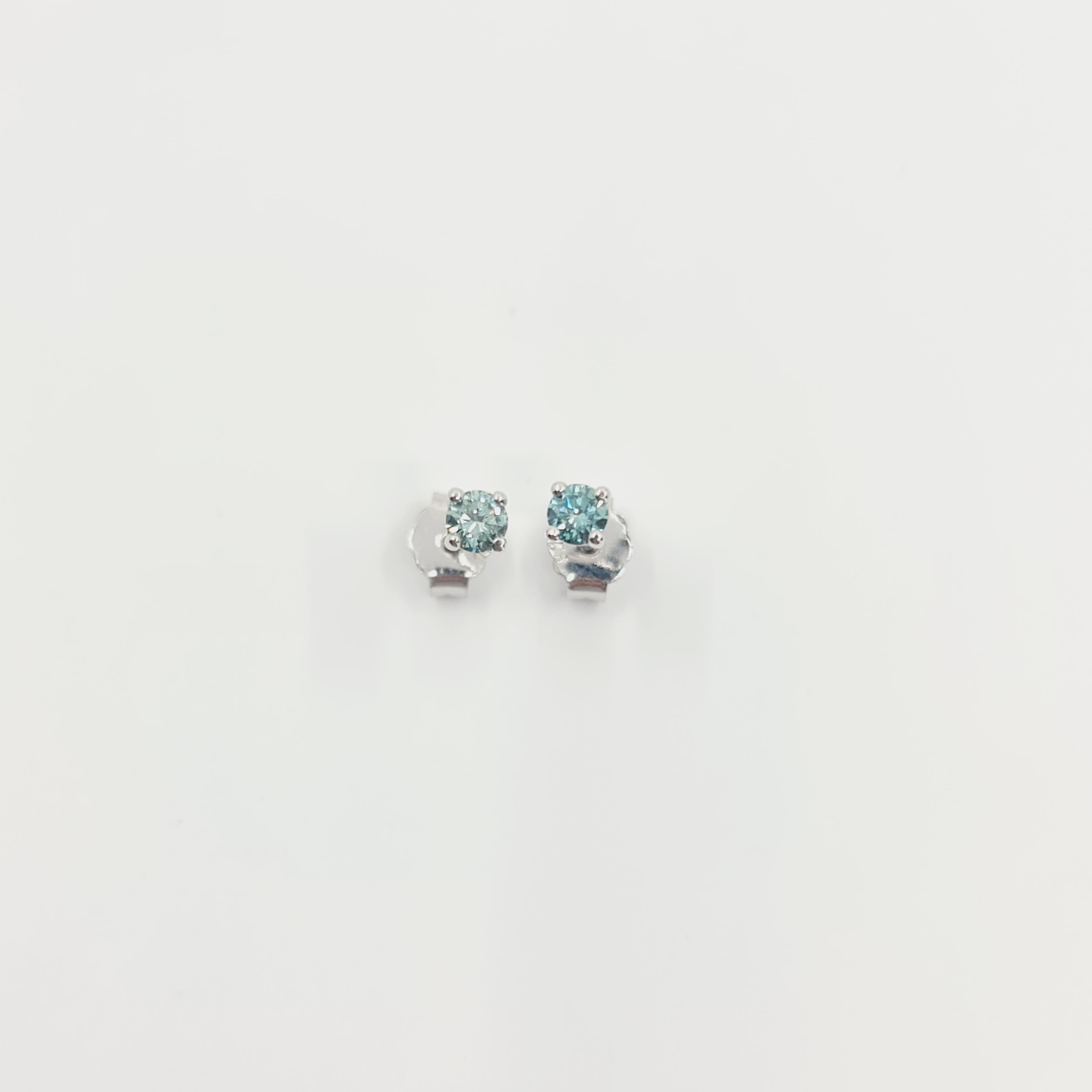 Fancy Blue-Green Diamond Earrings 0.27 Ct Fancy Intense Blue-Green/VS

Exceptional, Intense Blue-Green, Brilliant Cut Diamond Studs.  
Material: 18K White Gold 

4 C's:
Carat: 0,27ct
Color: Fancy Blue-Green(treated color)
Clarity: VS
Cut: Very