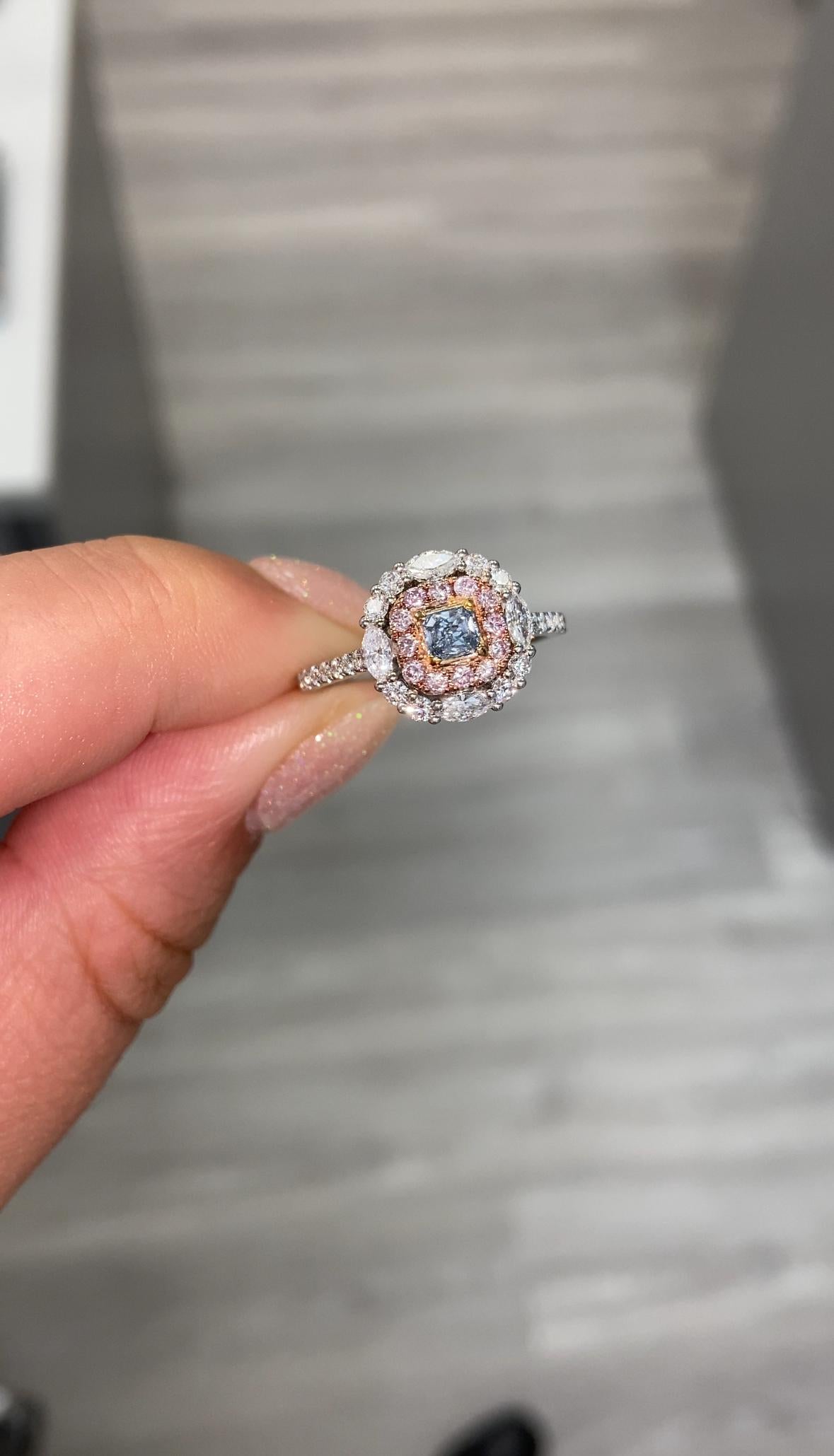 0.17 Carat Center Diamond 
Fancy Blue
Radiant Cut 
VS2 Clarity 
0.76 Carats of Surrounding Pink and White Marquises and Rounds 
GIA Certified Diamond
Crafted in Platinum
Handmade in NYC

This piece can be viewed before purchase in our showroom in