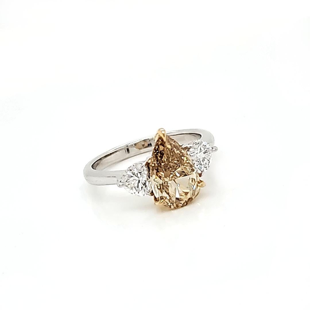Fancy Brown-Yellow Dia Pearshape ring cts 2.05

A tasteful combination of brown on yellow brings this attractively  shaped Pearshape diamond to the forefront of this classic ring. 
The side heart white diamonds add to the contrast and appeal of this