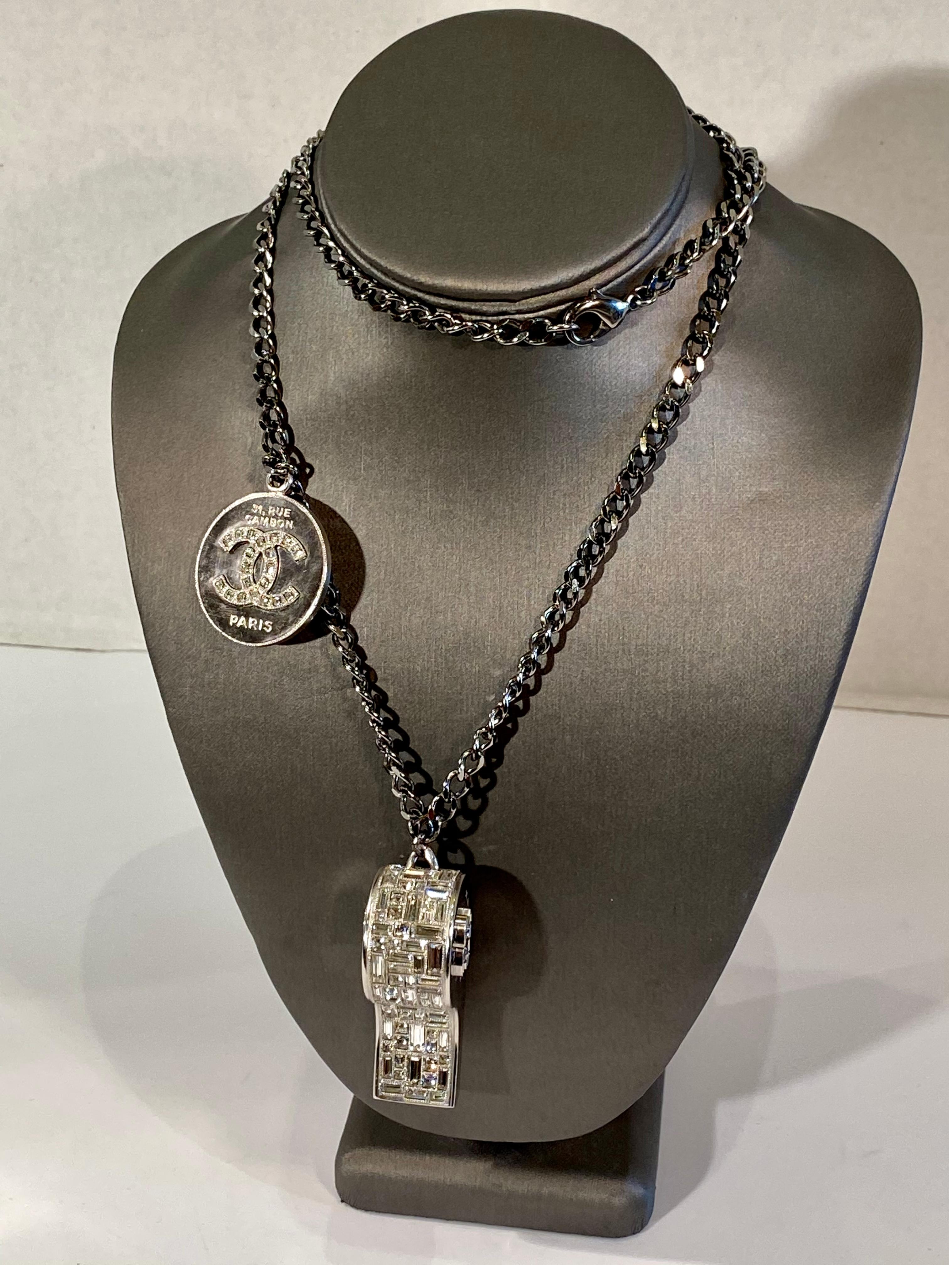 Rare and fabulous, fancy Chanel whistle pendant necklace from the Spring/Summer 2015 collection.  Crafted of silver tone metal, the whistle is exquisitely encrusted with baguette and square shaped Swarovski crystals and hangs from a ruthenium plated