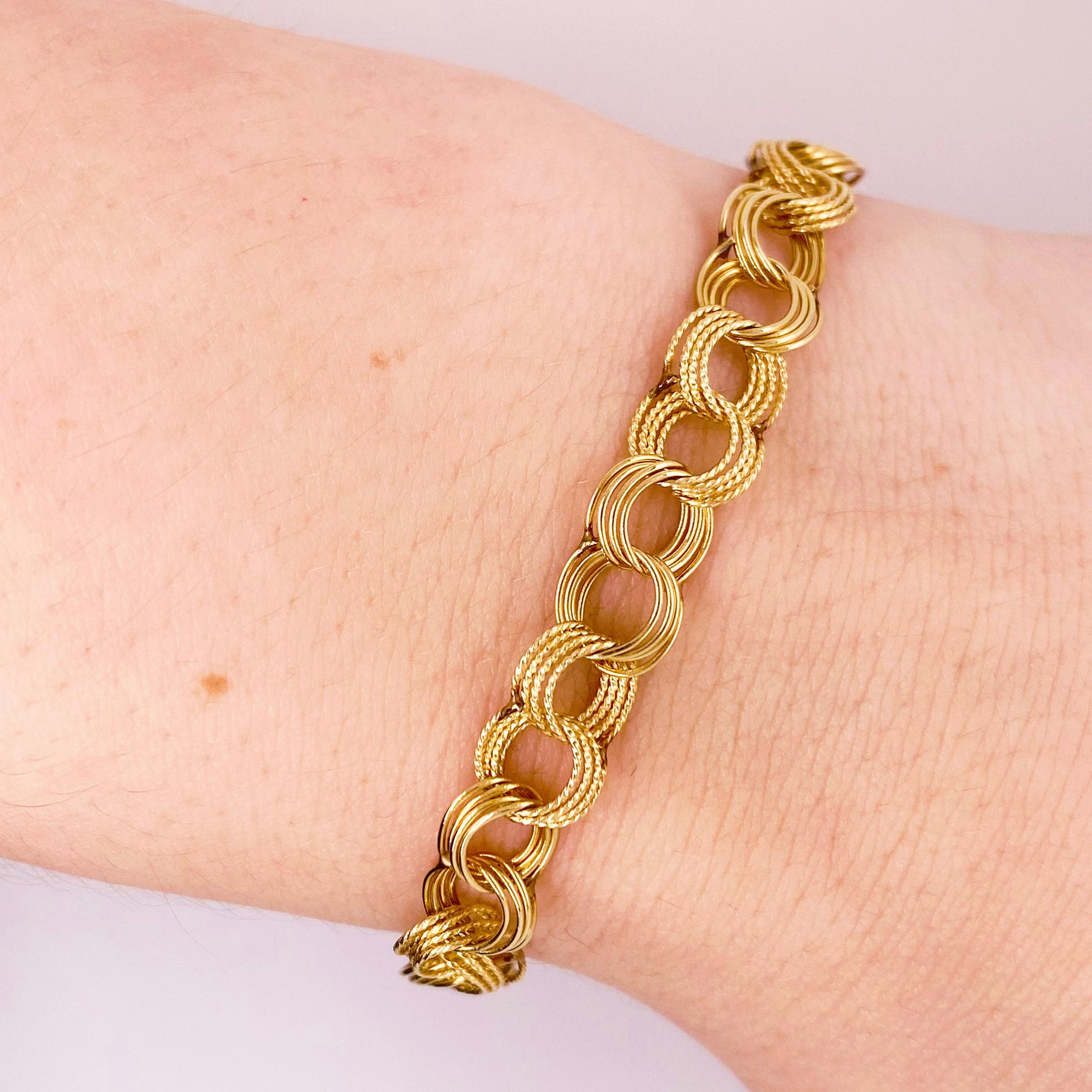 This is a handmade fancy link charm bracelet! Each link was handmade and put together to make this gorgeous, quadruple link design. The bracelet is solid 14 karat yellow gold with a strong lobster clasp. This bracelet can be worn on its own or can