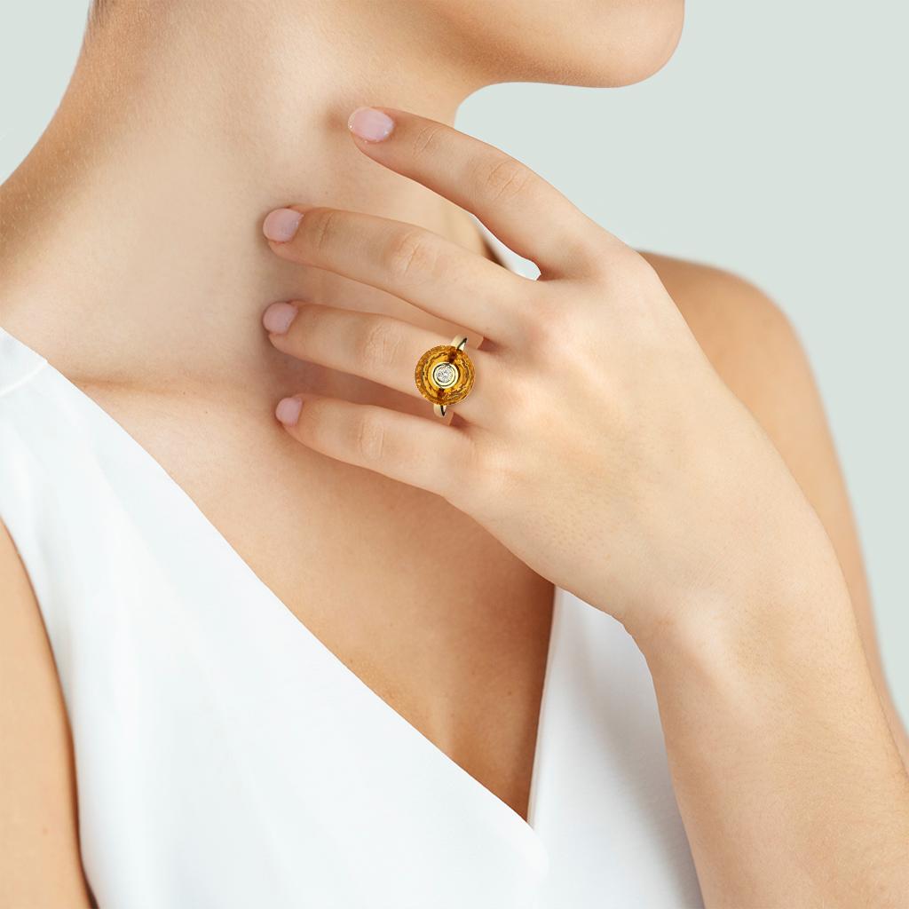 This fancy cut citrine will be noticed for the unique design and play of light with a sparkle of diamond on top set into a 14K yellow gold ring.

Hallmarks: 14K, 585

Center Gemstone
Gemstone: Citrine
Shape: Fancy Round Halo
Gemstone Measurements: