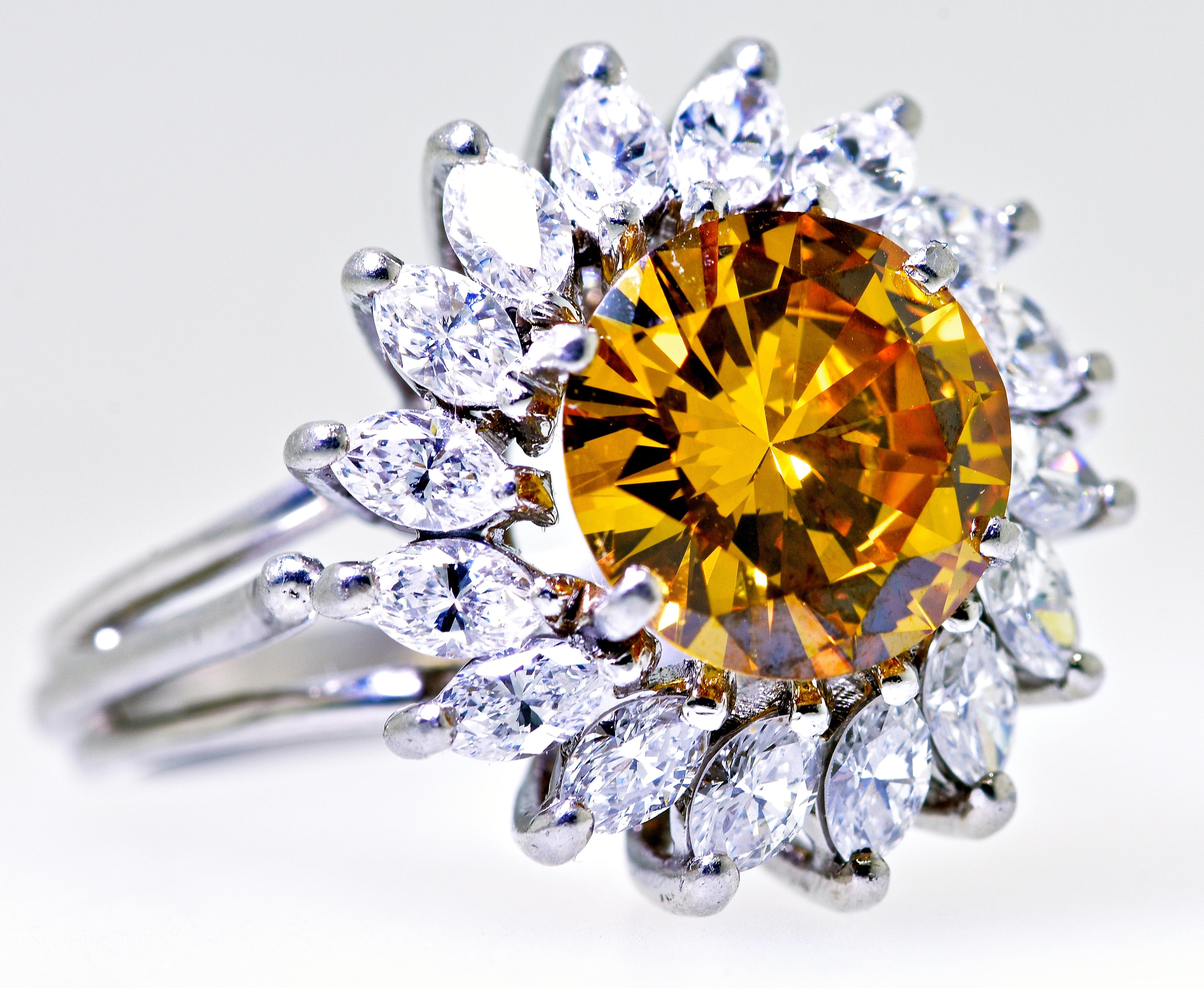 Diamond of a brilliant cognac (deep golden) color weighing 2.68 cts. This natural, well cut, diamond has been examined by the G.I.A. (Report No. 2430550), and has a genuine lab created cognac color.  The white marquis cut diamonds surrounding this