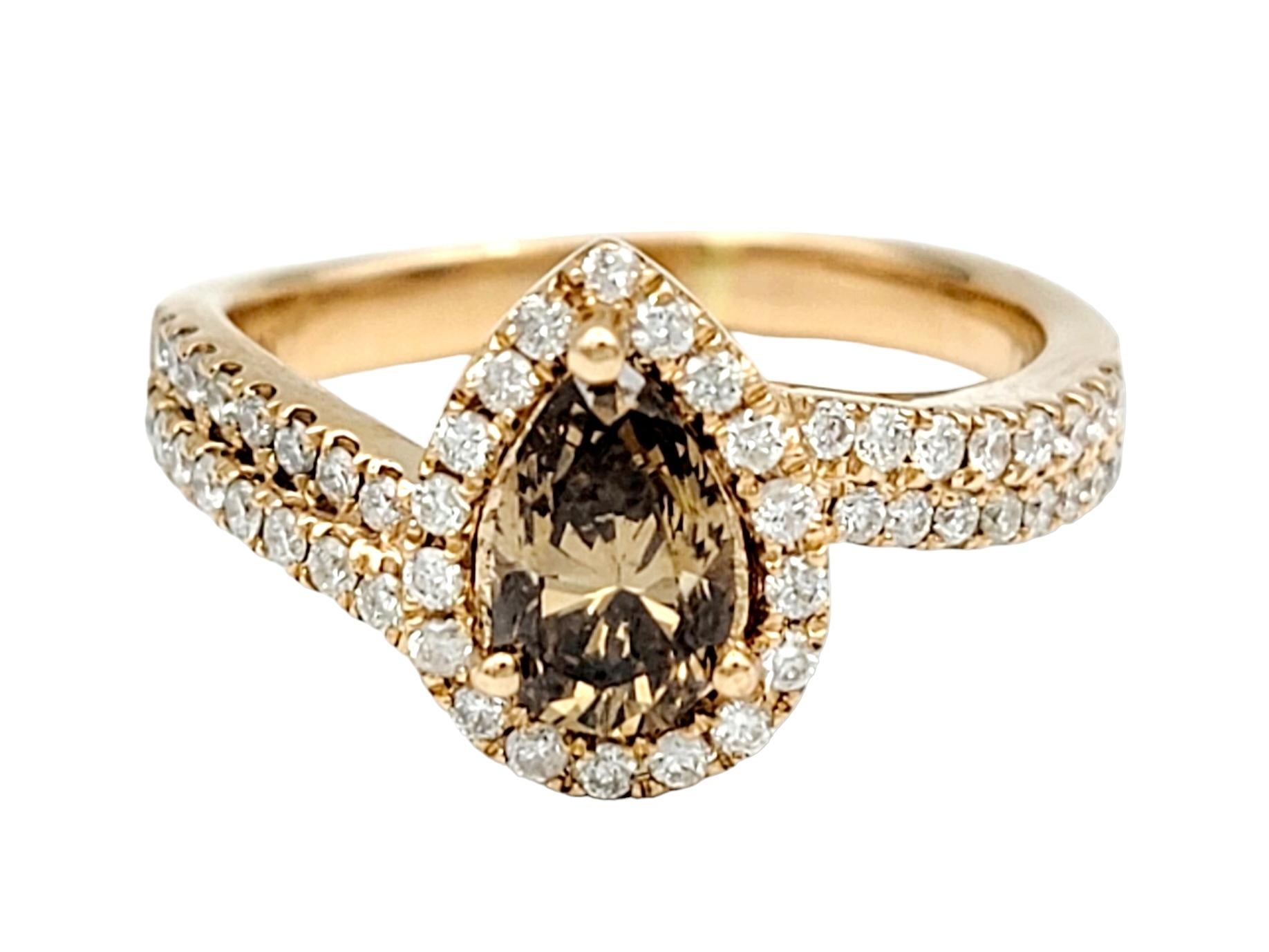 Ring Size: 5.25

This rich, warm and captivating cocktail ring, set in the embrace of 14 karat rose gold, is a must-have piece. The centerpiece is a striking pear-cut Fancy brown cognac diamond, an exquisite gemstone that emanates a unique and