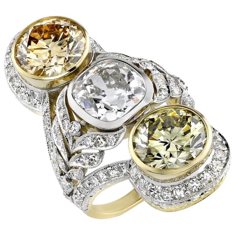 White- and colored-diamond, platinum and gold three-stone ring, 2018