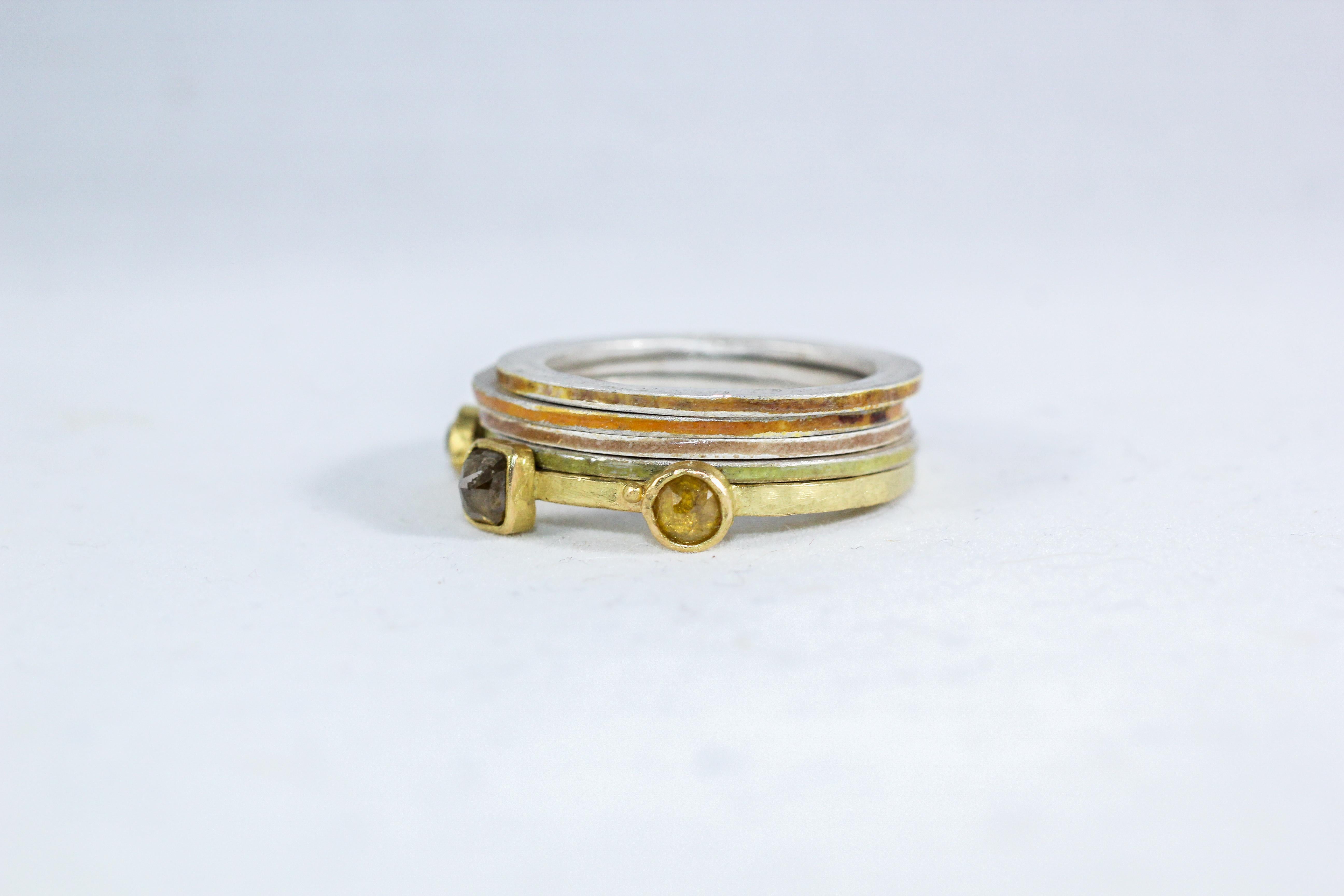 This three-stone diamond alternative engagement stack of bands combines our recycled 18k gold three-stone ring bezel set with three fancy colored diamonds and 4 enameled fine silver rings. The rich yellow of high carat gold is complemented by the