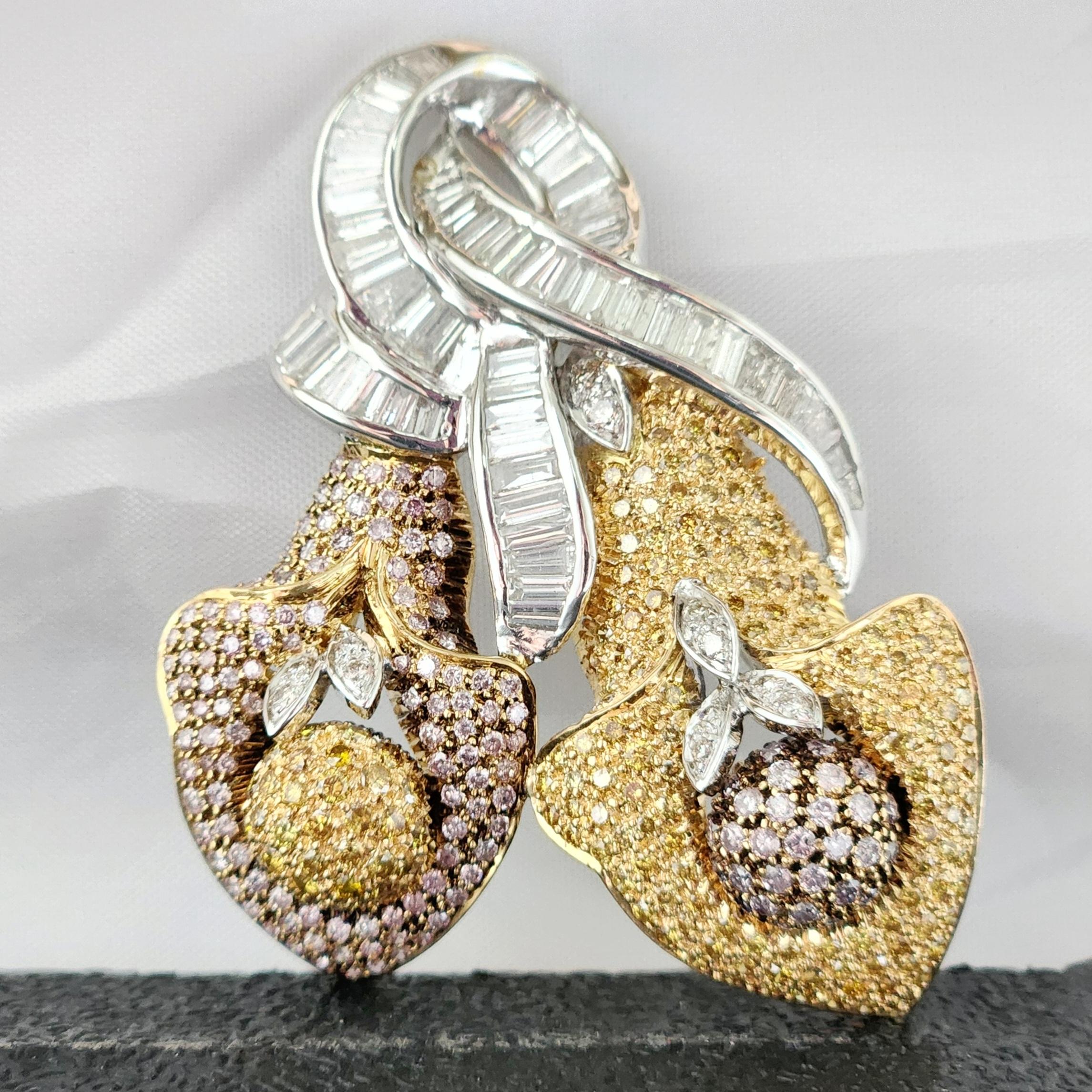 This exquisite Fancy Color Flower Shaped Brooch Pendent is a true masterpiece of craftsmanship. The center of attention is the two flower designs, which are adorned with pink and yellow melee diamonds as the center seeds having small leaves of white