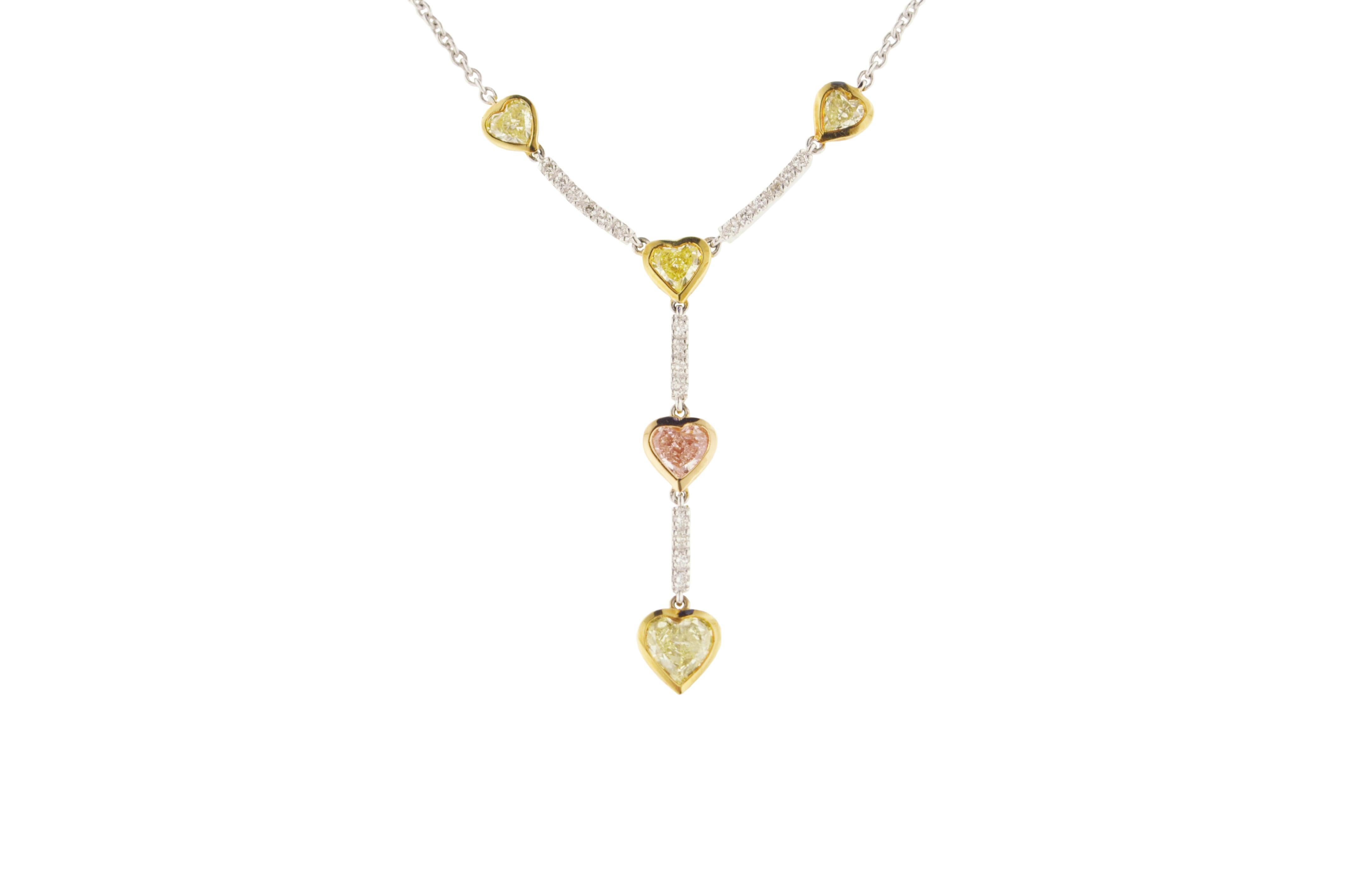 18K white and yellow gold pendant featuring four heart shape light yellow diamonds and one heart shape light pink diamond.

Diamonds:
4 Light Yellow Diamonds: 1.80 carats
1 Light Pink Diamond: 0.47 carats