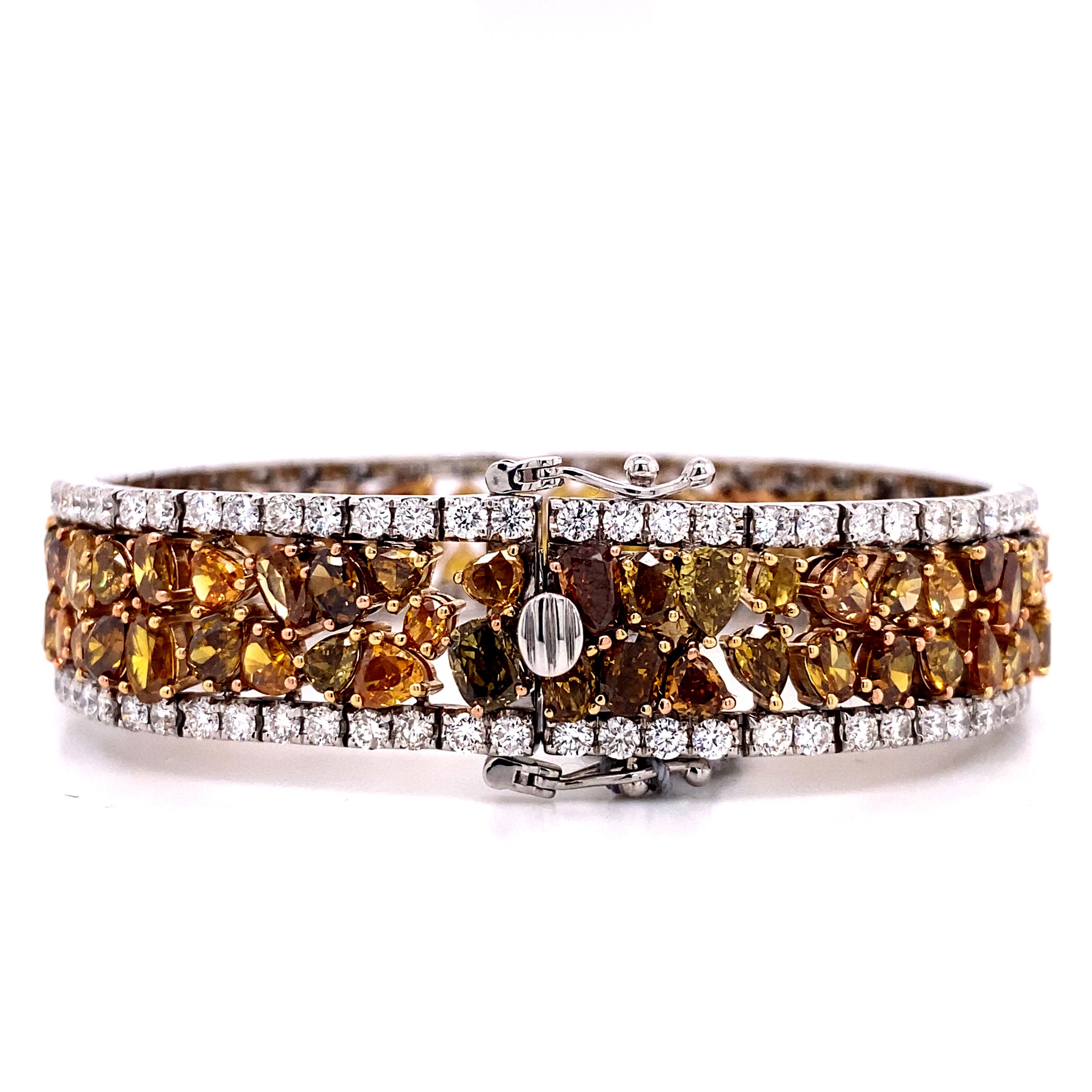 This extravagant diamond encrusted bracelet features 36 total carats of fancy colored natural diamonds in a seamless handmade design. It includes, fancy orange diamonds, fancy brown diamonds diamonds, and fancy yellow diamonds, all set into handmade
