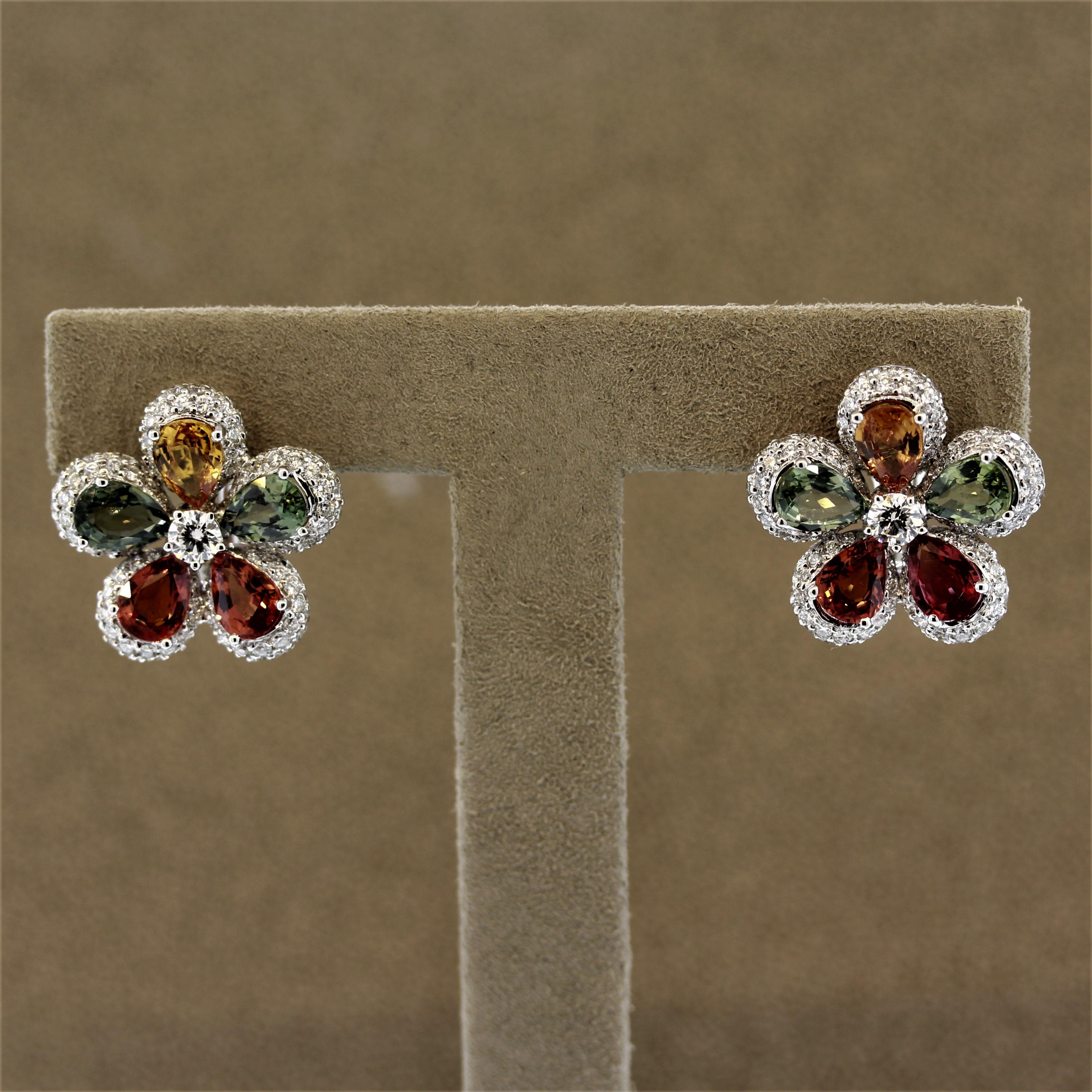 A beautiful pair of earrings featuring 10 pear shaped fancy colored sapphires weighing a total of 9.08 carats. They are accented by round brilliant cut diamonds set around the sapphires along with a larger diamond set in the center of the flower.