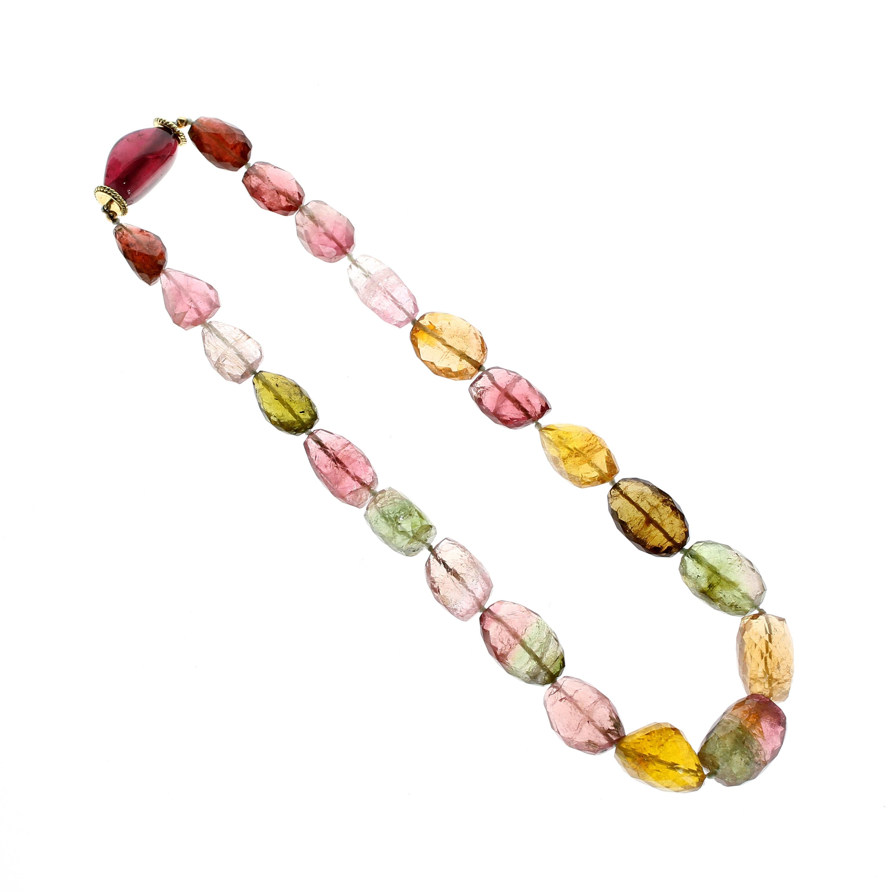 A unique and colorful gemstone bead necklace with various natural colors and organic shapes of tourmaline set in simple and easy-to-use 18kt yellow gold clasp. The one-strand necklace consists of twenty-two beads of tourmaline handsomely measuring
