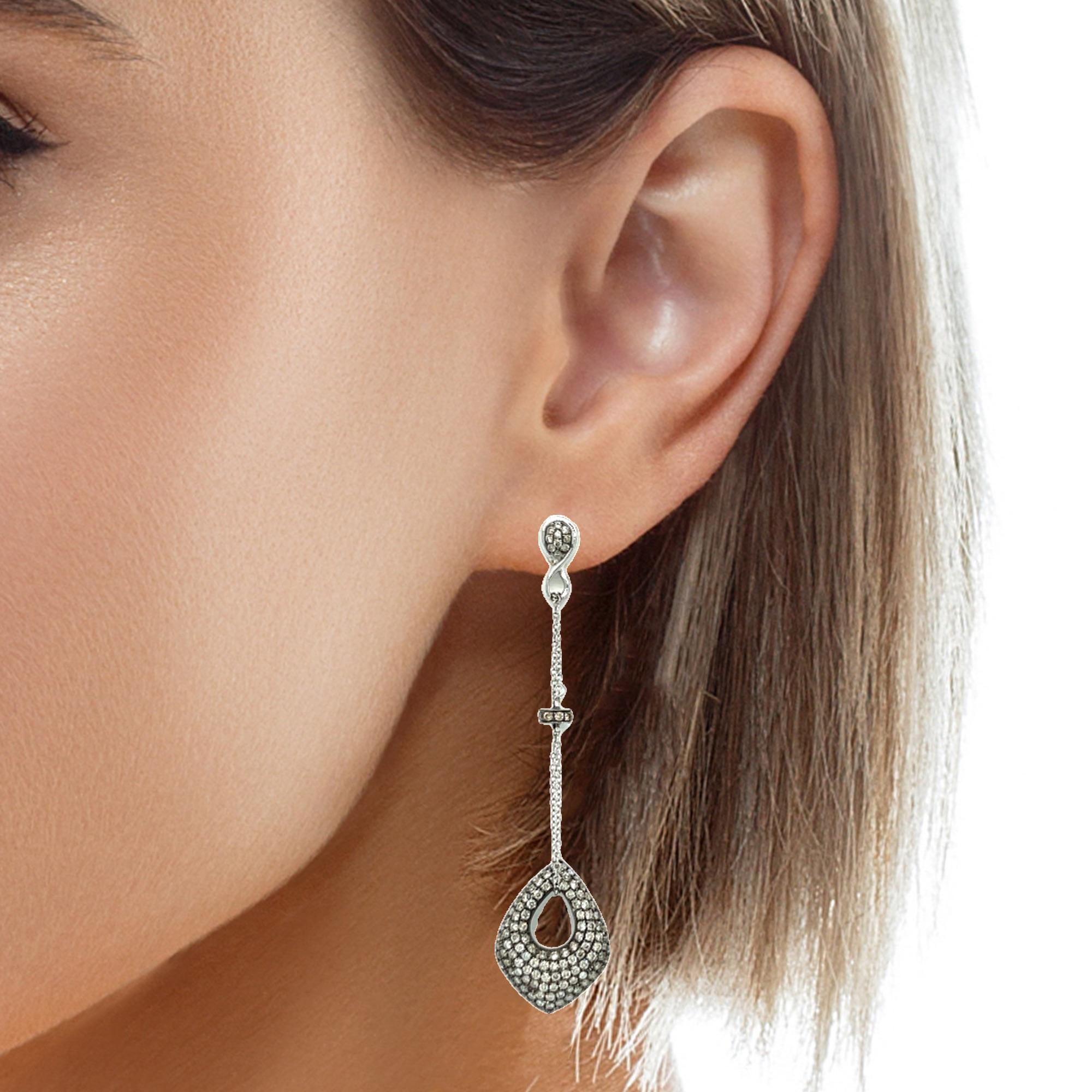 These stunning dangling earrings are surrounded with fancy Champagne and White diamonds and set in 18K gold. They are the perfect accessory for your cocktail event. They have double lock closure for extra security. These earrings come in a beautiful