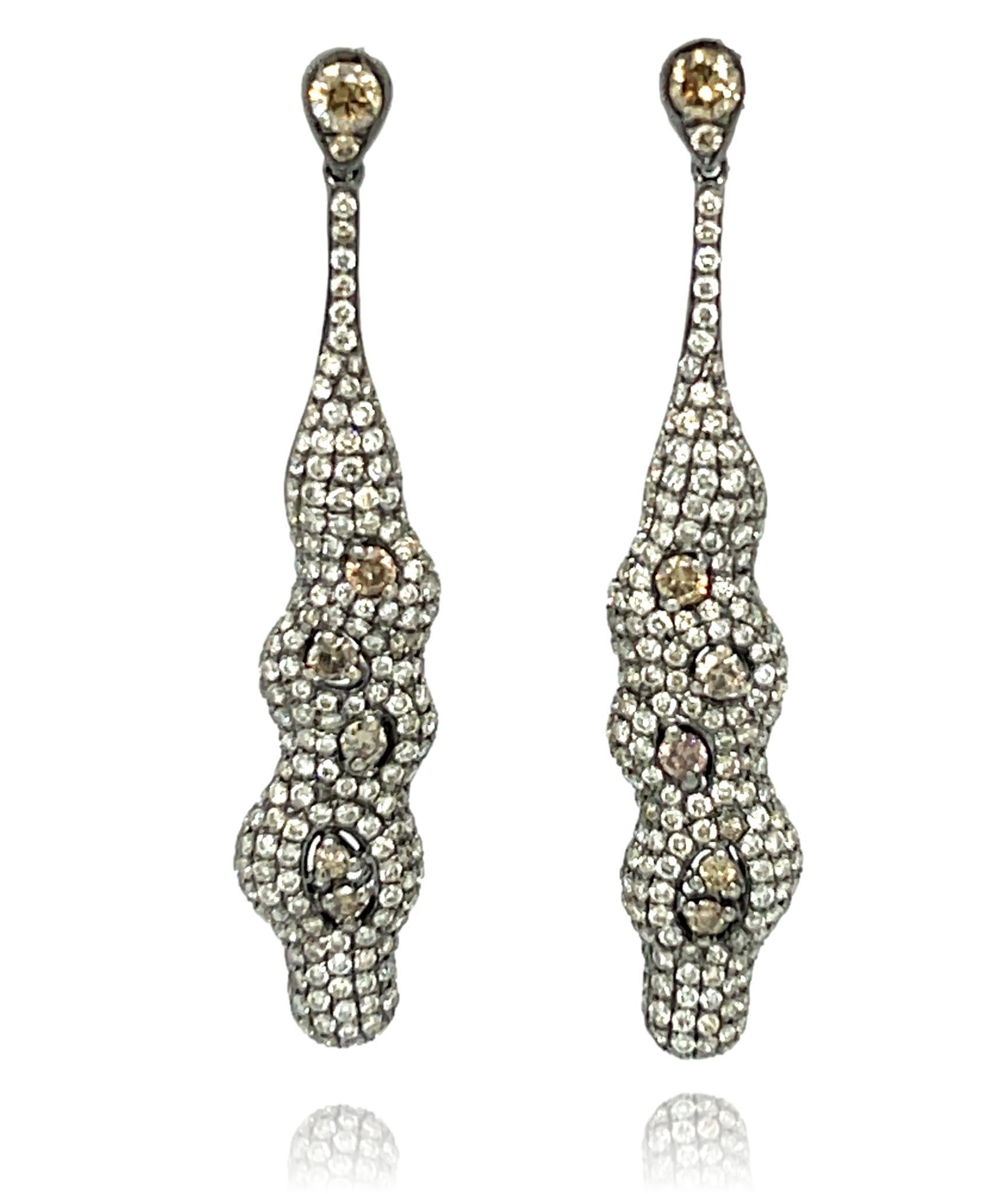 These stunning dangling earrings are surrounded with fancy Champagne and White diamonds and set in 18K gold. They have double lock closure for extra security. These earrings come in a beautiful box ready for the perfect gift! 

18KW:          7.05