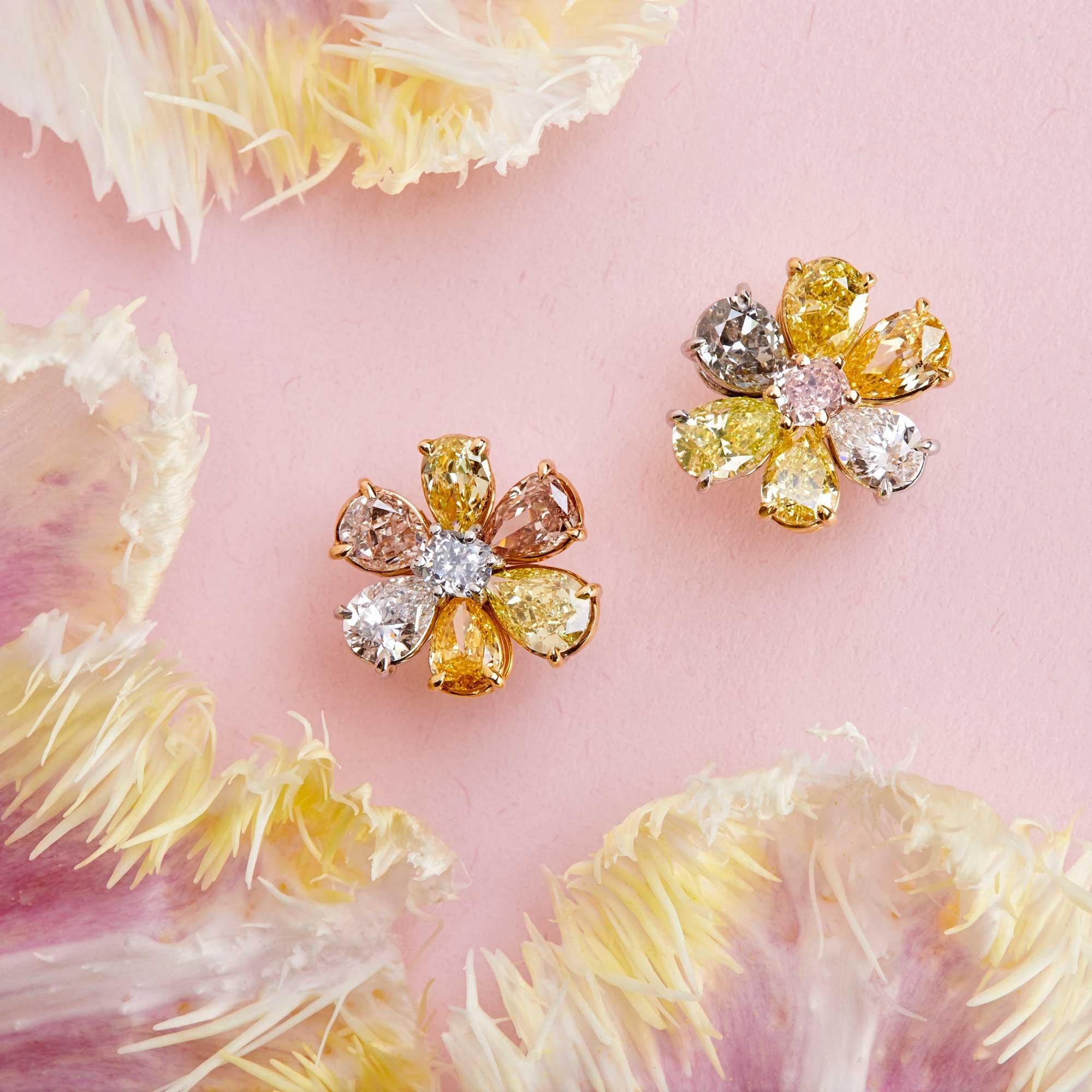 The petals of these flower earrings are composed of some of the hardest to find naturally-colored diamonds of such quality: fancy pink, fancy light gray-blue, fancy intense yellow, fancy intense yellowish orange, fancy brownish orangey pink, fancy