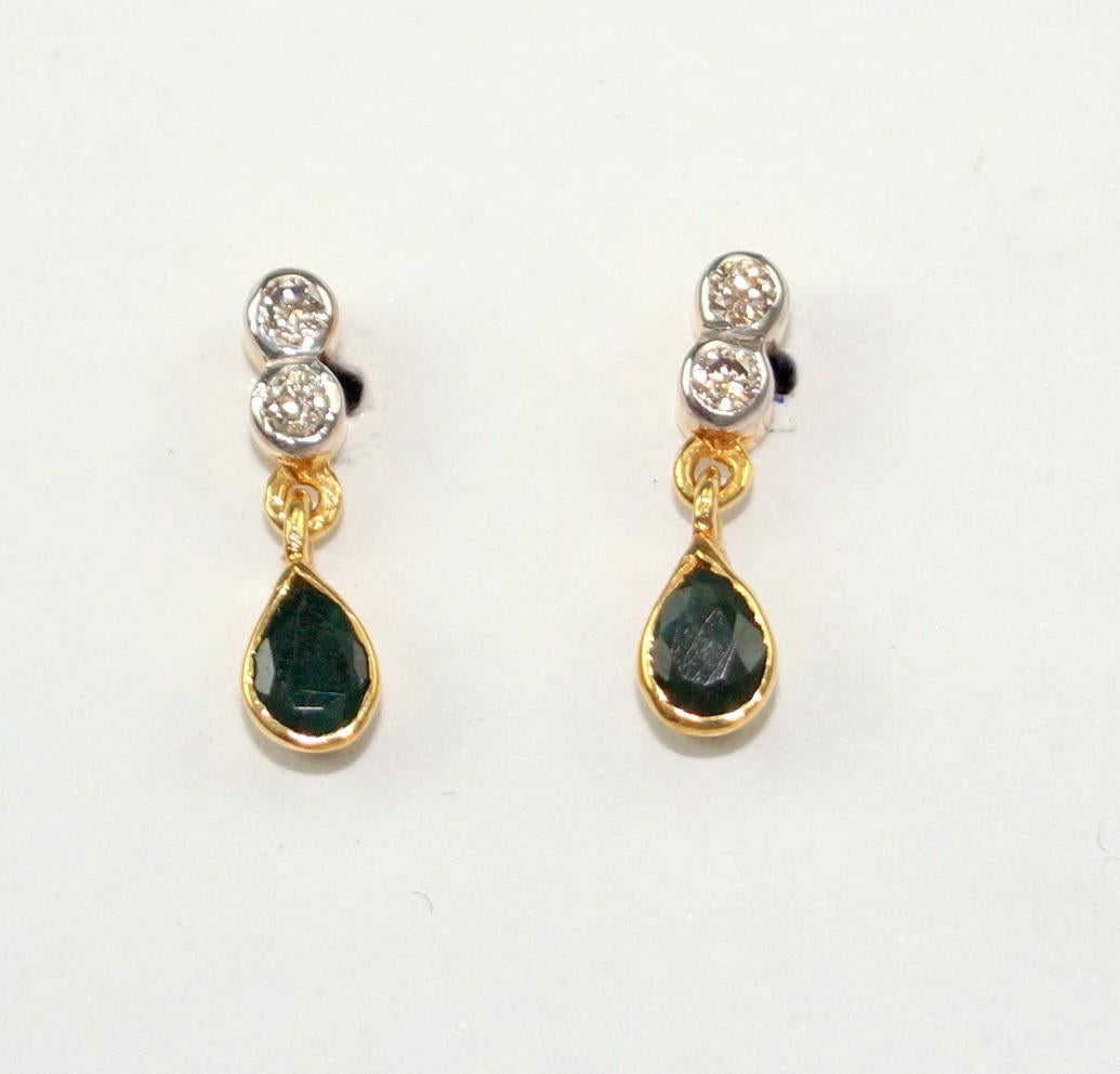 Stunning diamond silver emerald earrings consists of :

Metal- Silver
Metal Purity- sterling silver
Color of metal- Yellow gold plating 
Diamond- Natural uncut diamonds
Diamond origin- Natural earth mined
Diamond weight- 0.50cts
Gemstone- Natural