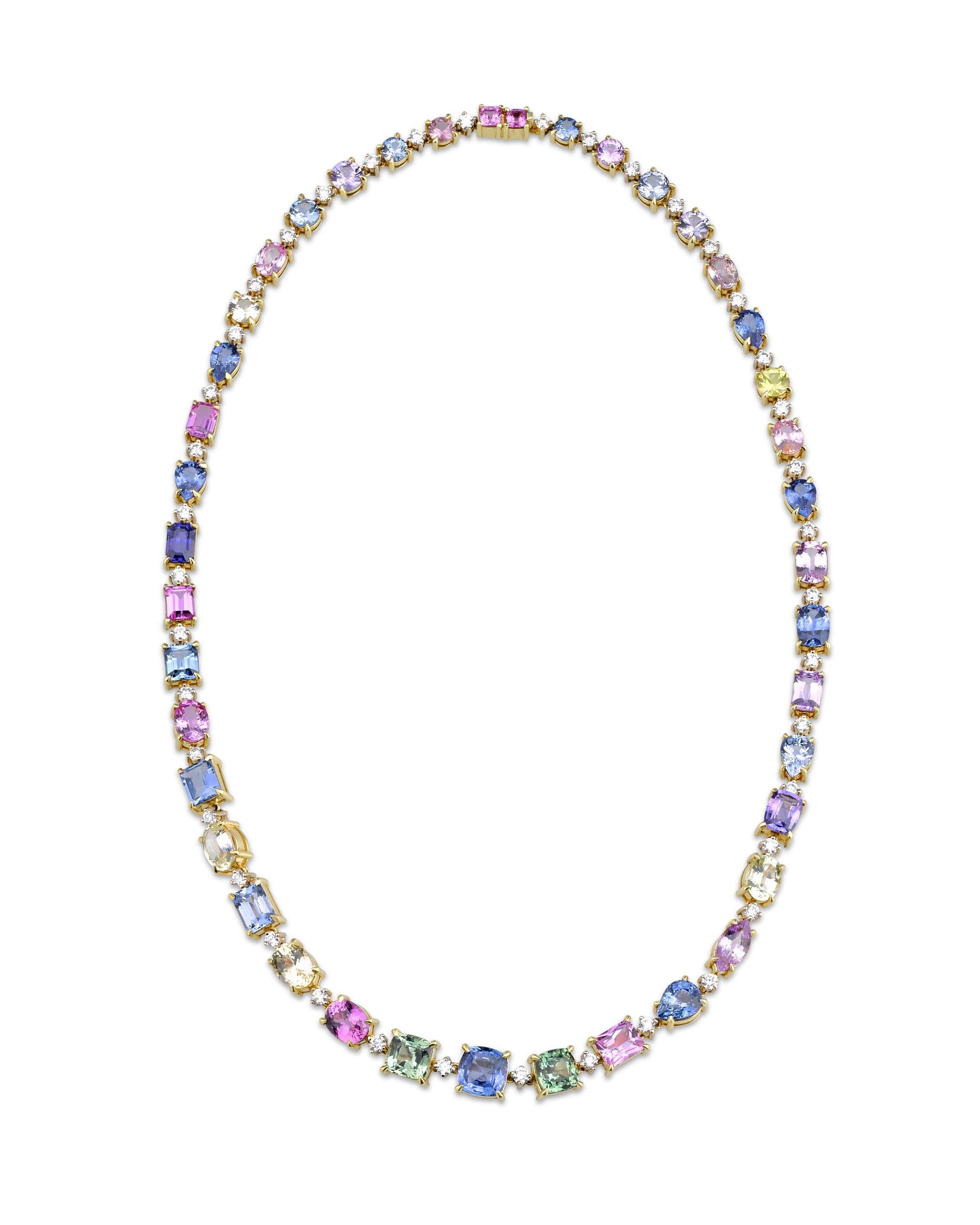 This extraordinary, multi-color sapphire and diamond necklace showcases 57.39 total carats of Ceylon sapphires. The spectacular sapphires exhibit a vibrant array of hues, from brilliant yellow and vivid violet to sea green, bold blue, and pale pink.