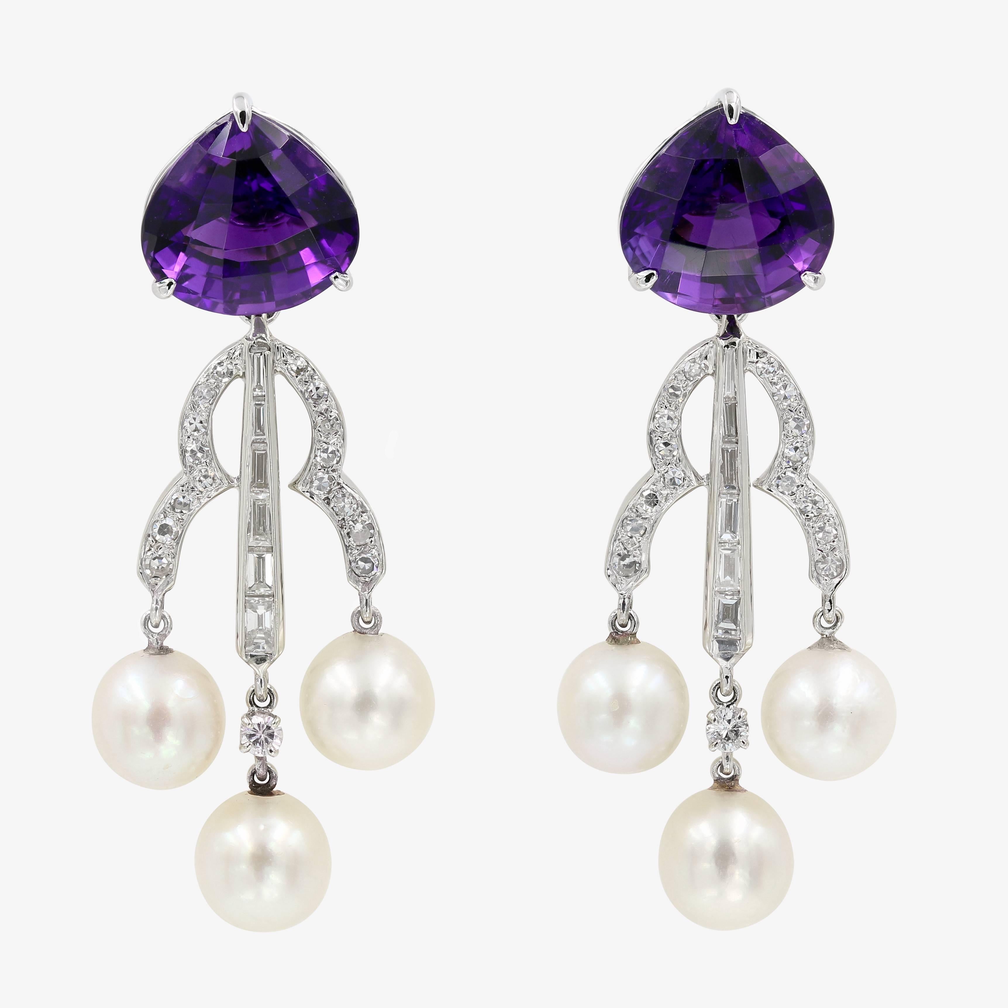 These unique earrings in 14kt. white gold contain 2 matched fancy cut amethysts=15.25cts. t.w. and are accented by 32 single cut round diamonds approximately .50ct. t.w. (G in color and VS in clarity), 2 round diamonds approximately .14ct. t.w. (G