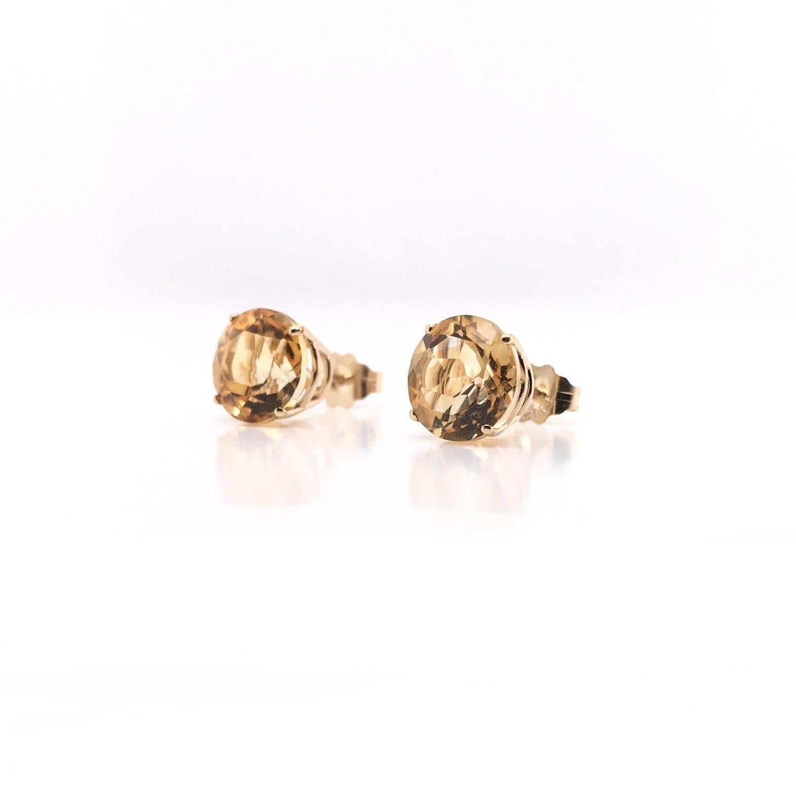 These beautiful citrine earrings are a contemporary estate piece. The simple settings are 14k gold and incredibly minimal; the gorgeous stones are the center of attention! These lightly hued citrines are fancy cut for maximum sparkle. We love the