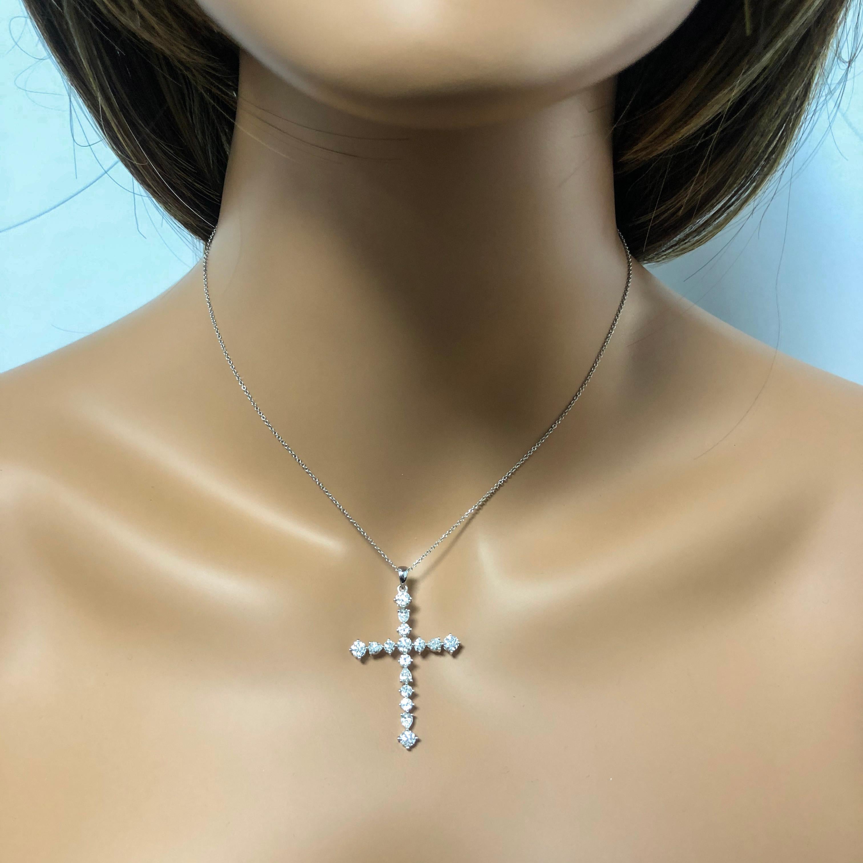 Cross Pendant Necklace set with different cut diamonds 16 different cut diamonds. Each corner ends with a round brilliant diamond. Diamonds weigh 2.23 carats total. Made in 18k white gold. Hangs on a 16 inch 18k gold chain.

Style available in