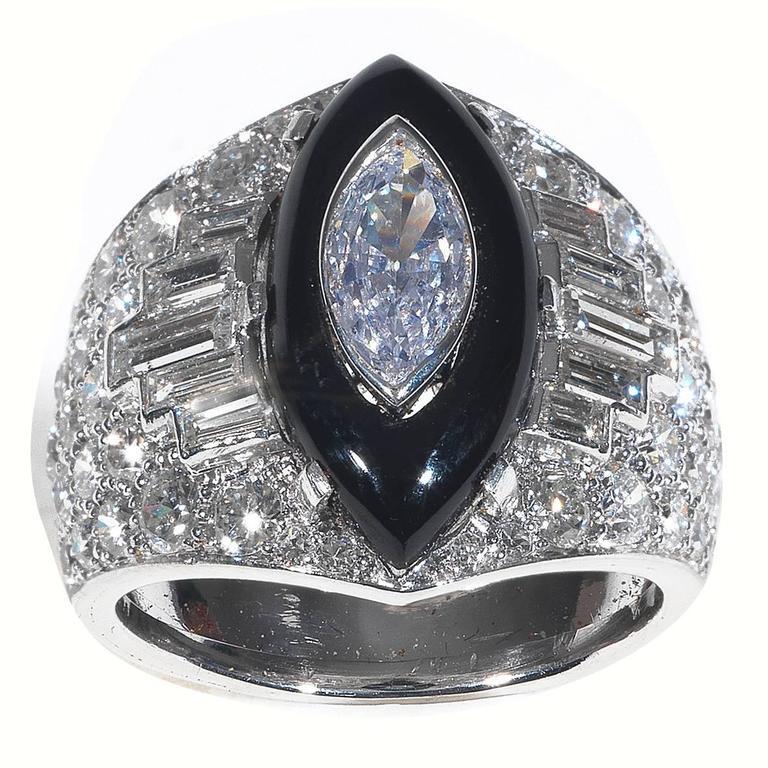 Designed with a claw set onyx in the centre set with a collet set marquise cut diamond weighing 0.65 cts, the shoulders with baguette and round cut diamond, weighing respectively 1.45 and 2.50 cts.

Mounted in platinum

Finger size: 7

Weight: 11.8