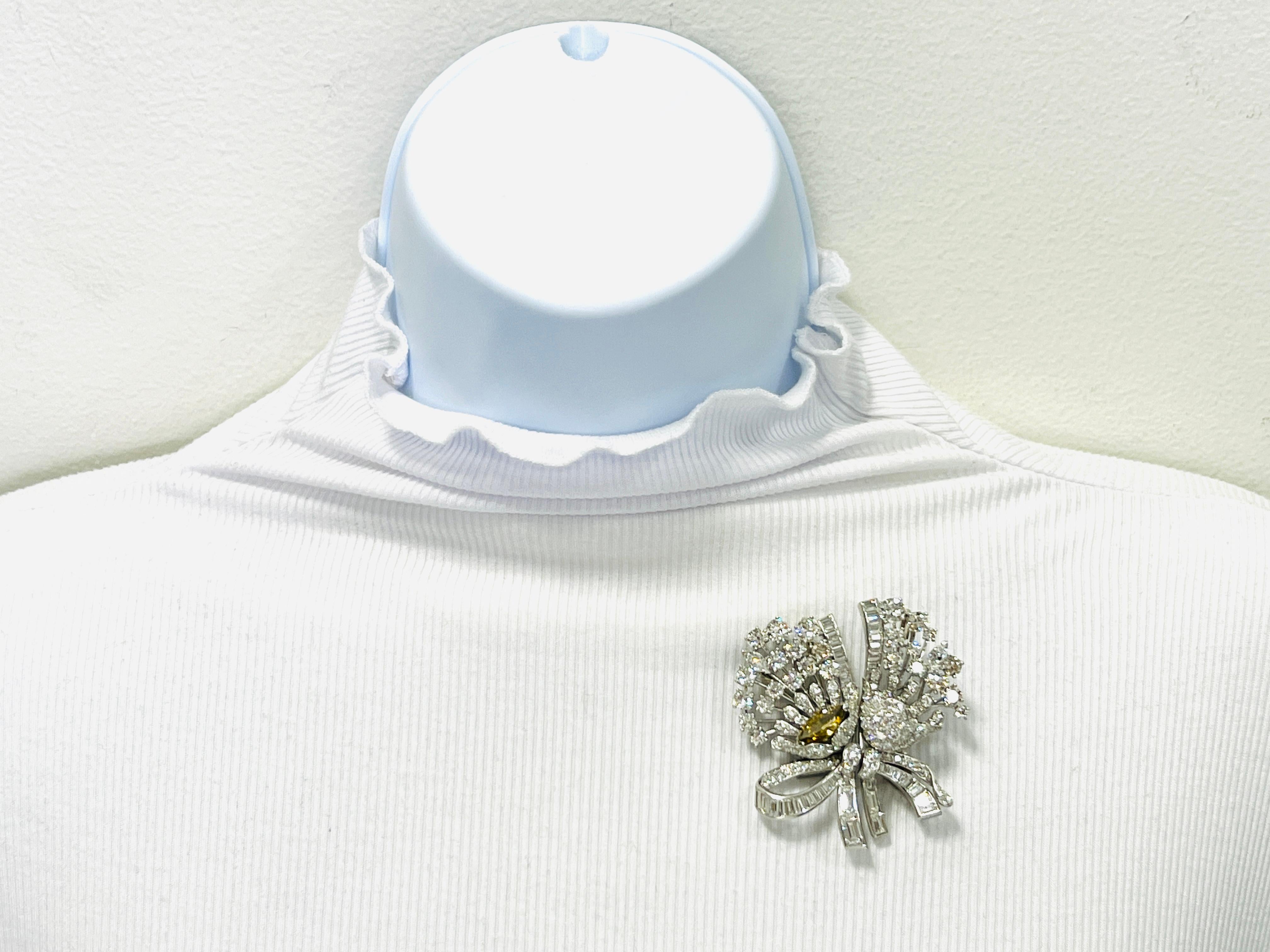 Beautiful 1.97 ct. fancy deep brownish yellow diamond marquise with good quality white diamond baguettes and rounds.  Handmade in 18k white gold.  Can be worn as two connected brooches or separately, giving this piece great versatility.