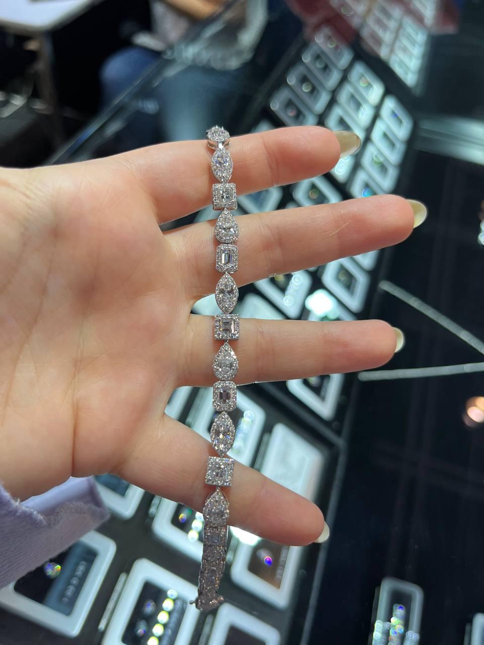 A beautifully linked Diamond Bracelet set with Total 7.88 CARAT of a variety of fancy shaped Diamonds. A total of 21Fancy shaped  Diamonds all set in around a Halo of 349  small Round Diamonds. Linked together elegantly to decorate your wrist! In