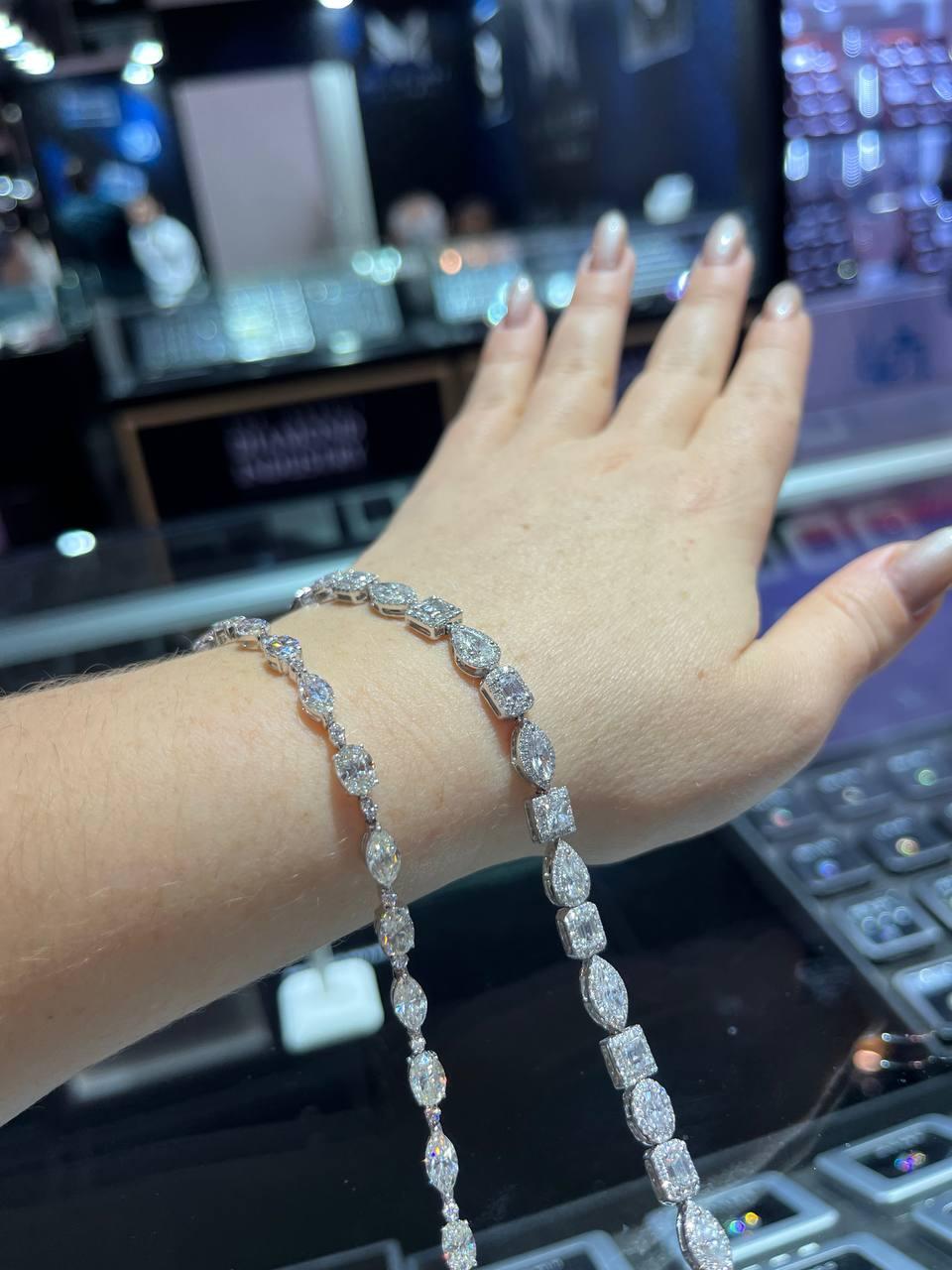 A beautifully linked Diamond Bracelet with Total 12.59 CARAT of Oval and Marquise Shaped Diamonds. This modern tennis bracelet with fancy diamonds falls elegantly from your wrist! In the IMAGES this Bracelet is on the one on the LEFT SIDE. You can