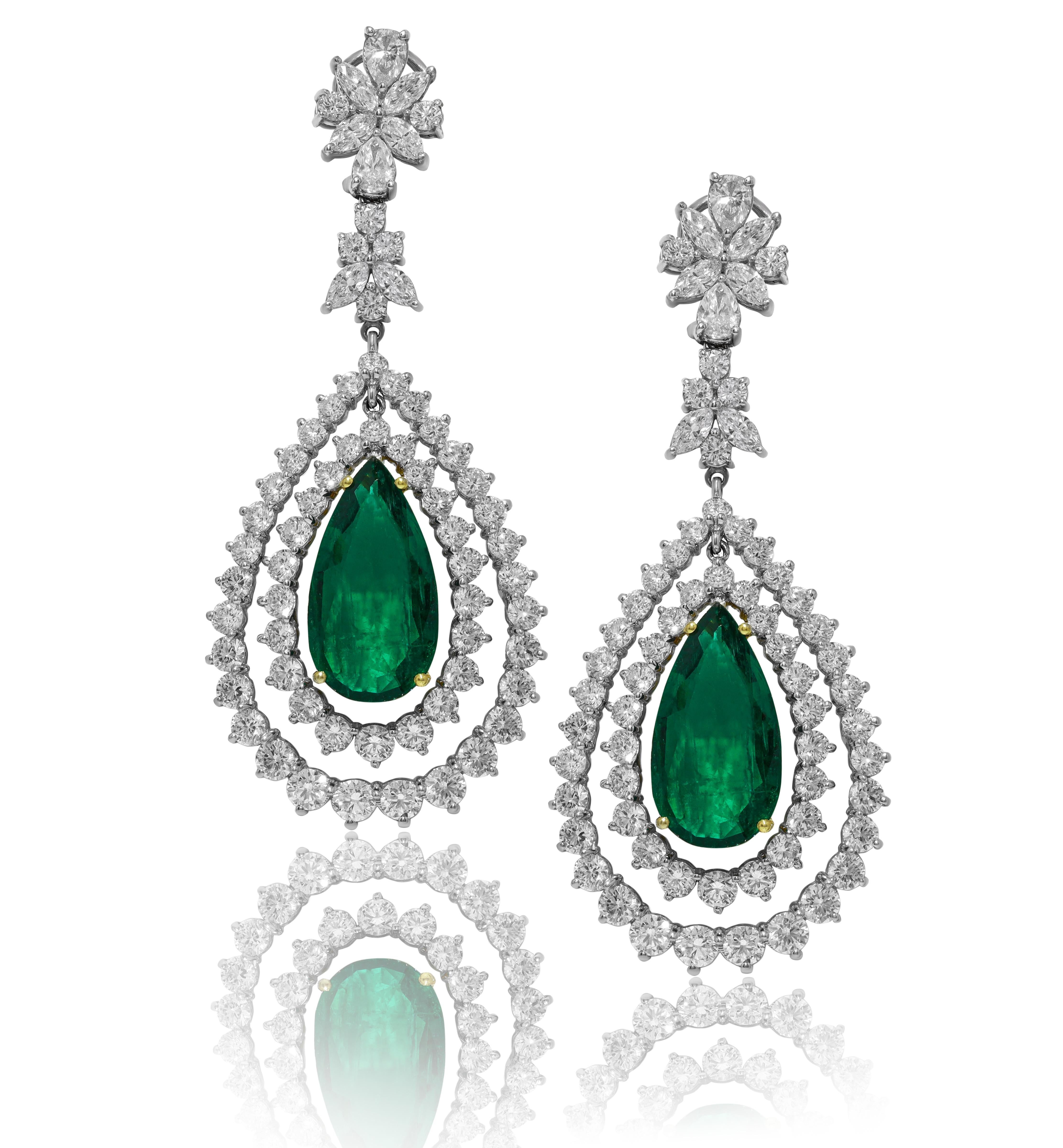 Fancy diamond emerald earrings set with 19.21 two emeralds/pear shape and two rows of round diamonds all around and dangles from two cluster clips/ps&mq
