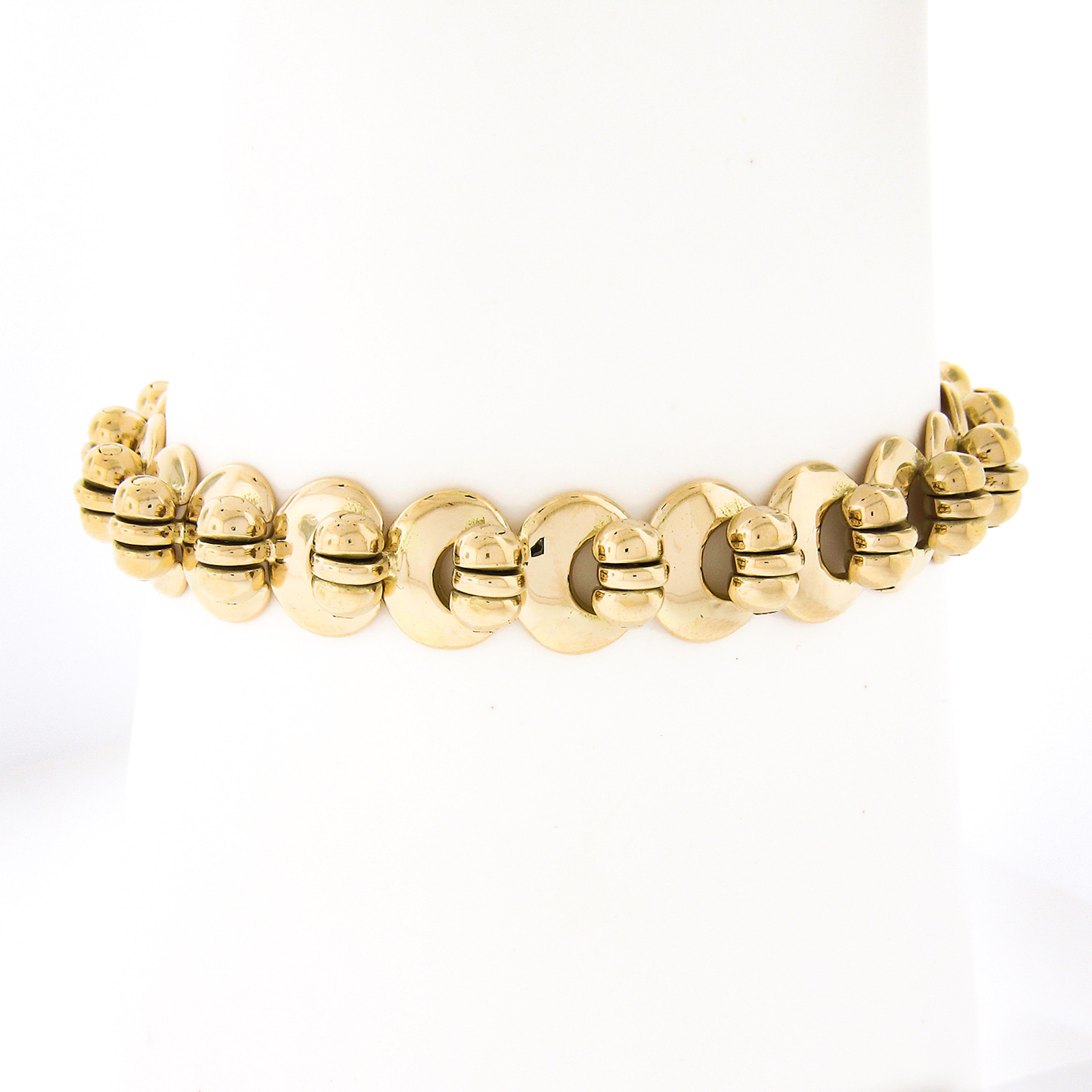 This fancy and very well made chain bracelet was crafted from solid 18k yellow gold. The beautiful handmade chain has a very unique design that is constructed from high-polished hinged links neatly set throughout and attaches with an oversized