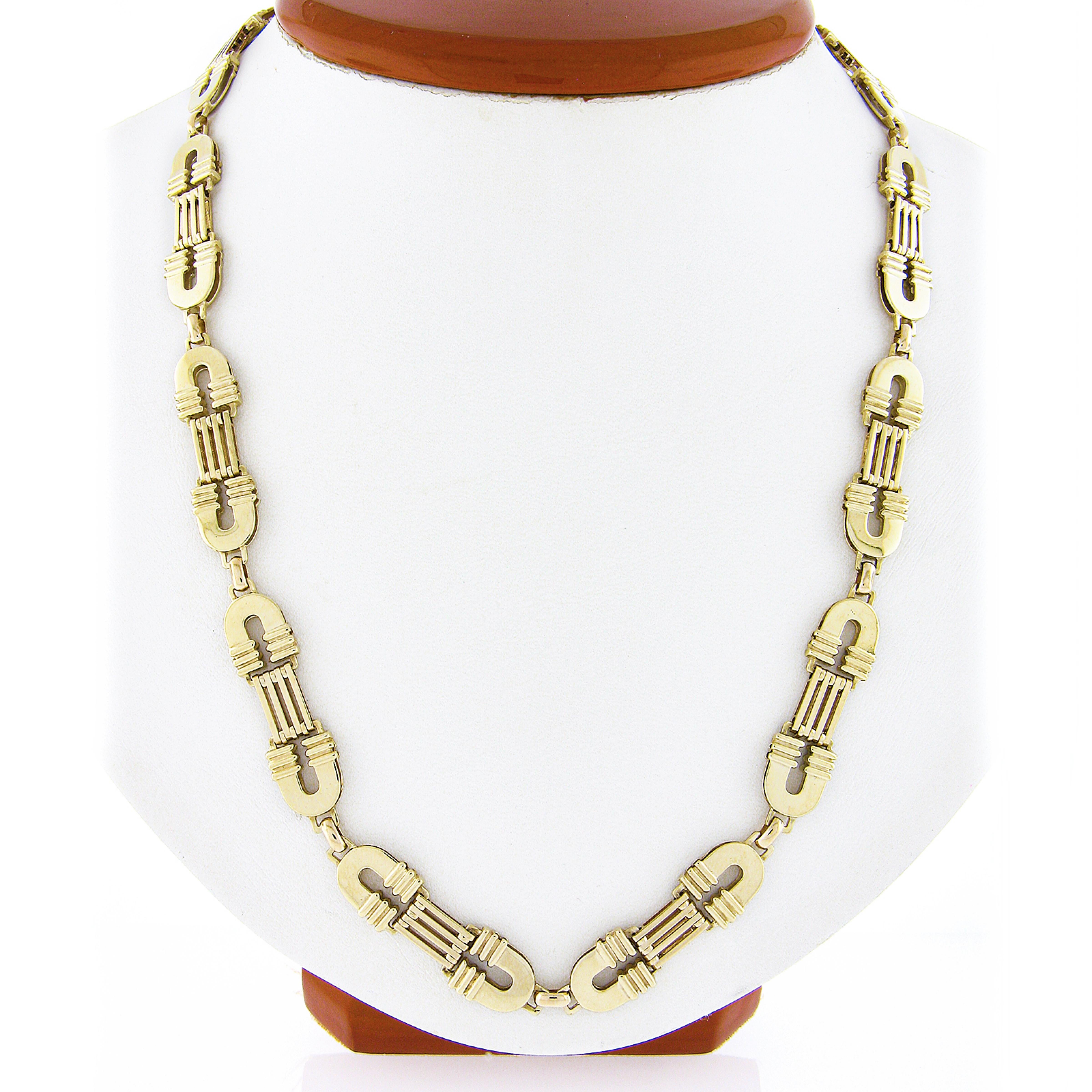 This fancy and well made chain necklace was crafted in Italy from solid 14k yellow gold. The beautiful handmade chain has a very unique design that is constructed from high-polished flexible links neatly interlocking throughout and attaches with an
