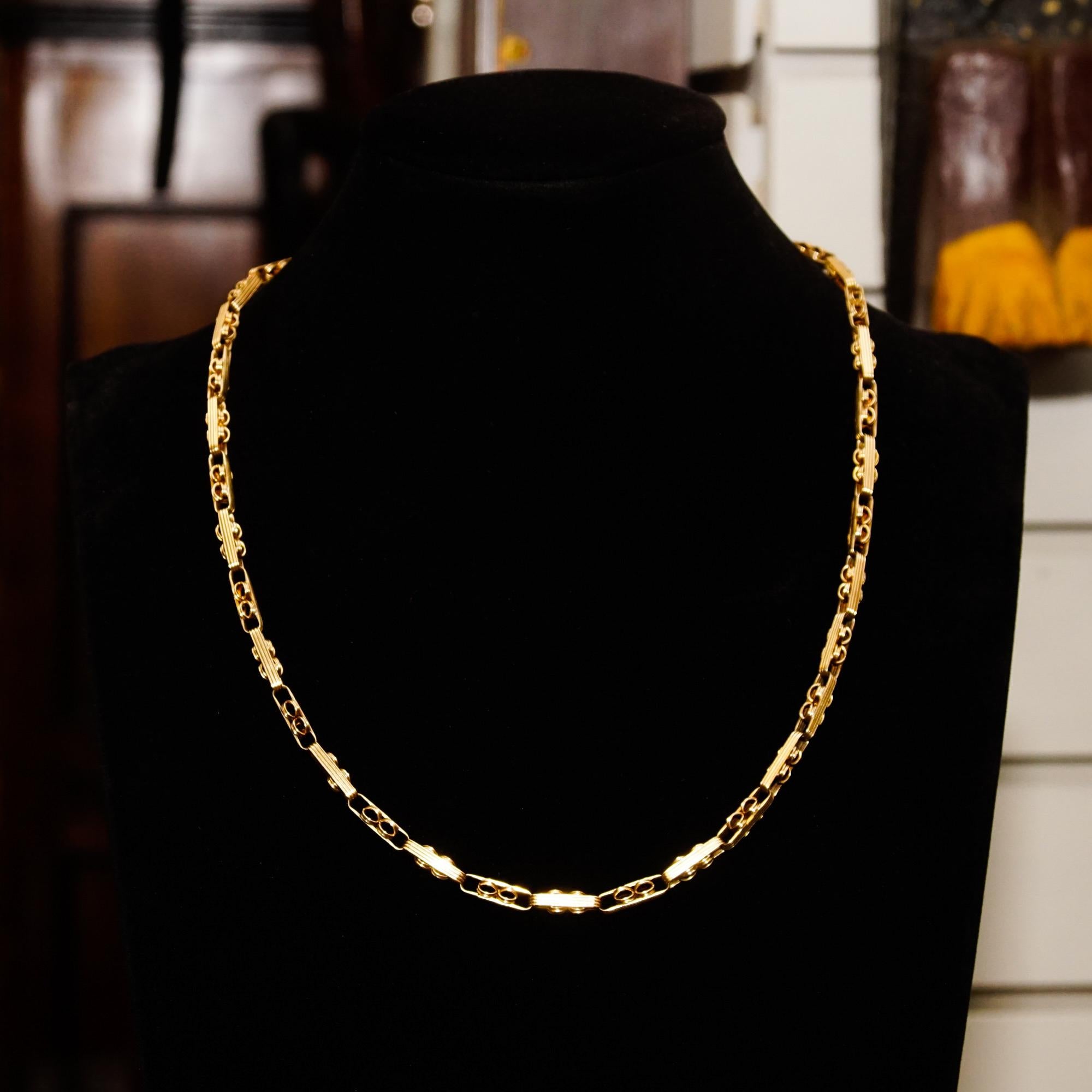 An incredibly well-preserved antique 14k fancy link chain necklace, originally a ladies pocket watch accessories. Features a 4mm wide infinity link pattern with ridged details and a rounded bead style decoration. The chain measures 19 inches long