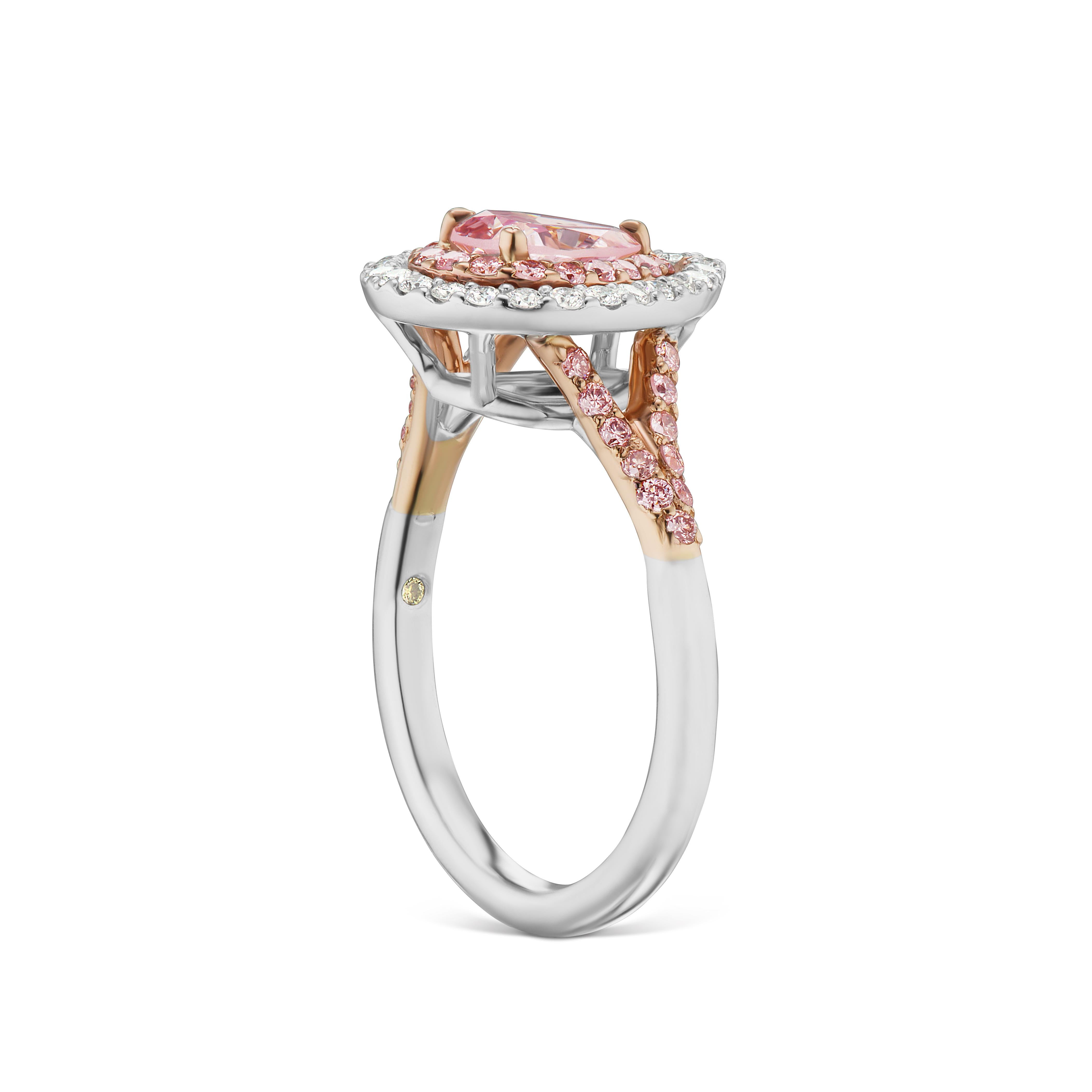 This Fancy Intense Purple-Pink .81 ct Pear Shaped Diamond in Platinum and 18kt Rose gold steals the show! It's set with and additional halo of  .39 ct total weight of fancy intense Pink melee, along with another .24 ct total weight of white EVS