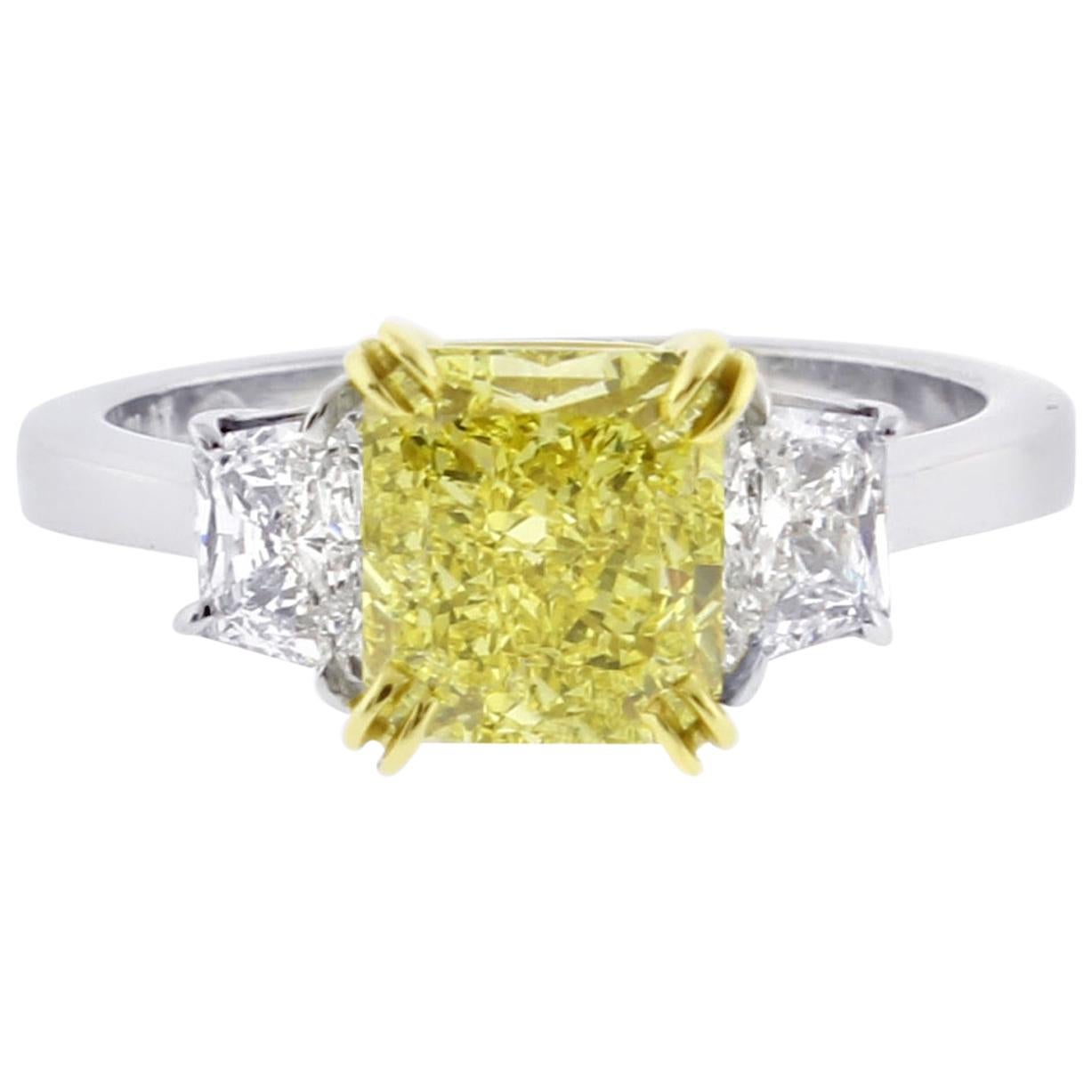 Fancy Intense Yellow 1.74 Carat Radiant Diamond Three-Stone Ring from Pampillona For Sale