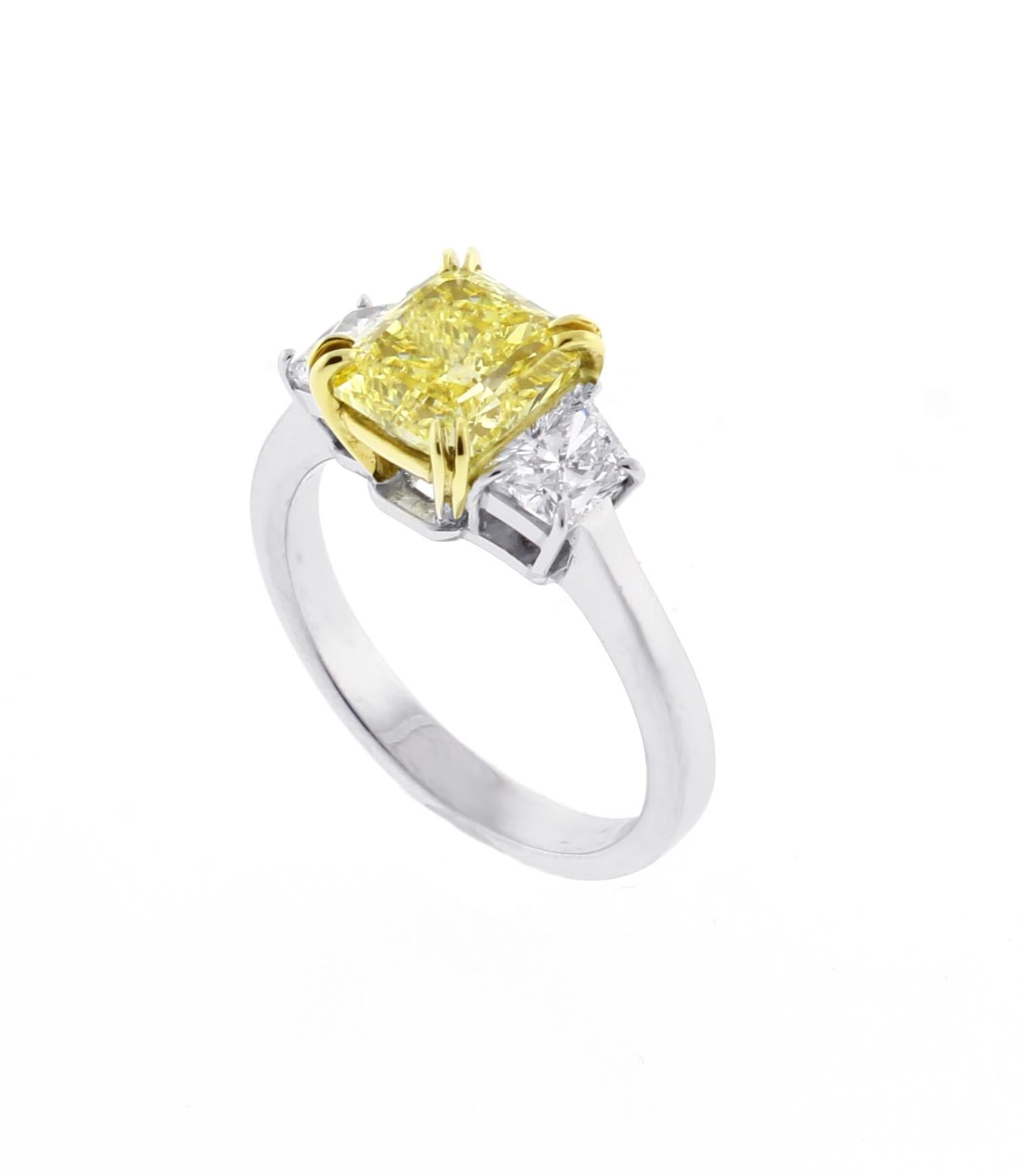 
From the master ring makers of Pampillonia jewelers, this stunning natural fancy intense yellow diamond three stone ring
♦ Designer: Pampillonia
♦ Metal: Platinum and 18 karat
♦ Radiant cut diamond= 1.74  carats VS1 clarity G.I.A
♦ 2 trapezoid