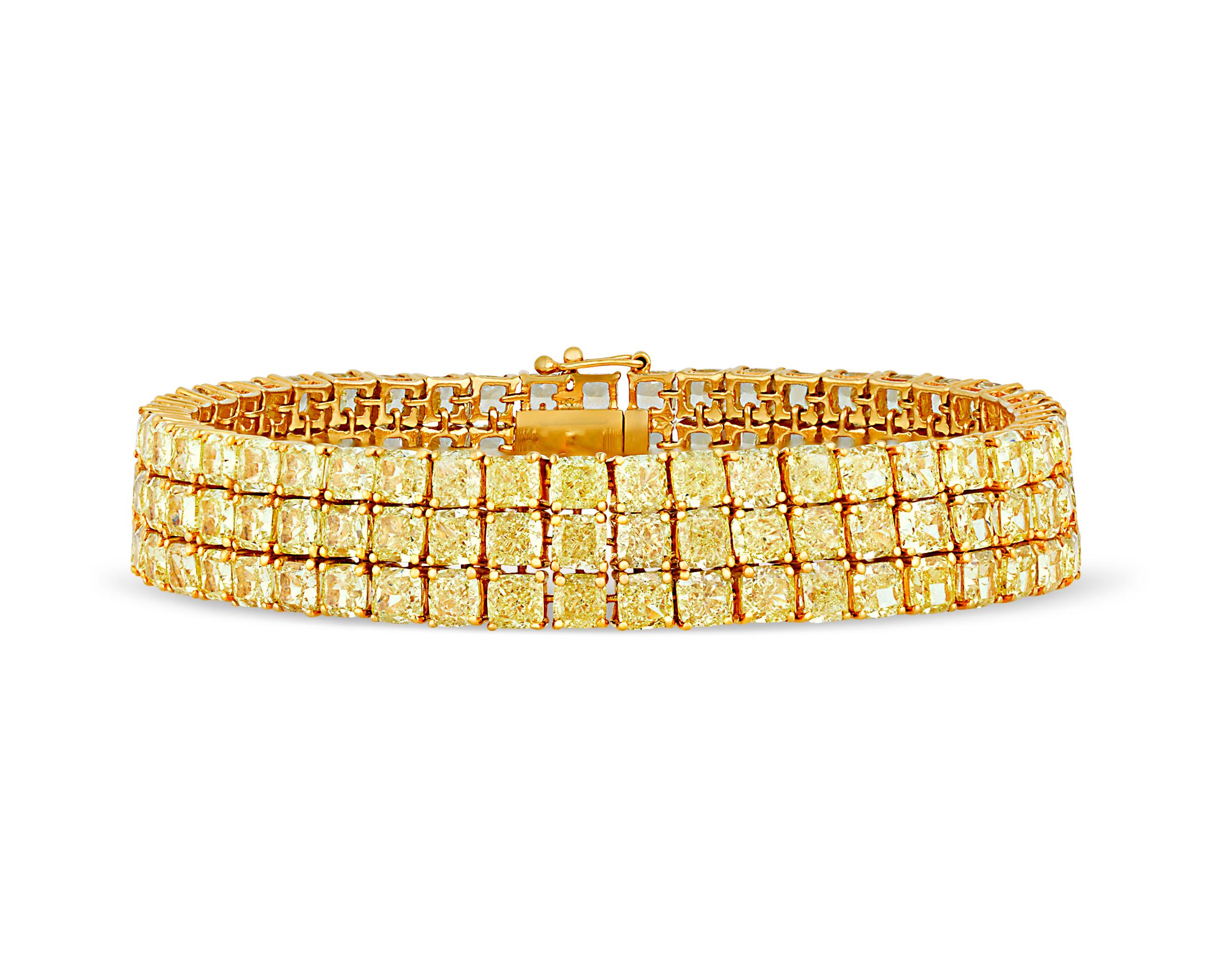 Brilliant fancy intense yellow diamonds line the entire length of this tennis bracelet. This classic jewelry creation features an incredible 141 of these perfectly-matched jewels totaling 41.43 carats, each mounted in neat rows in an 18K gold