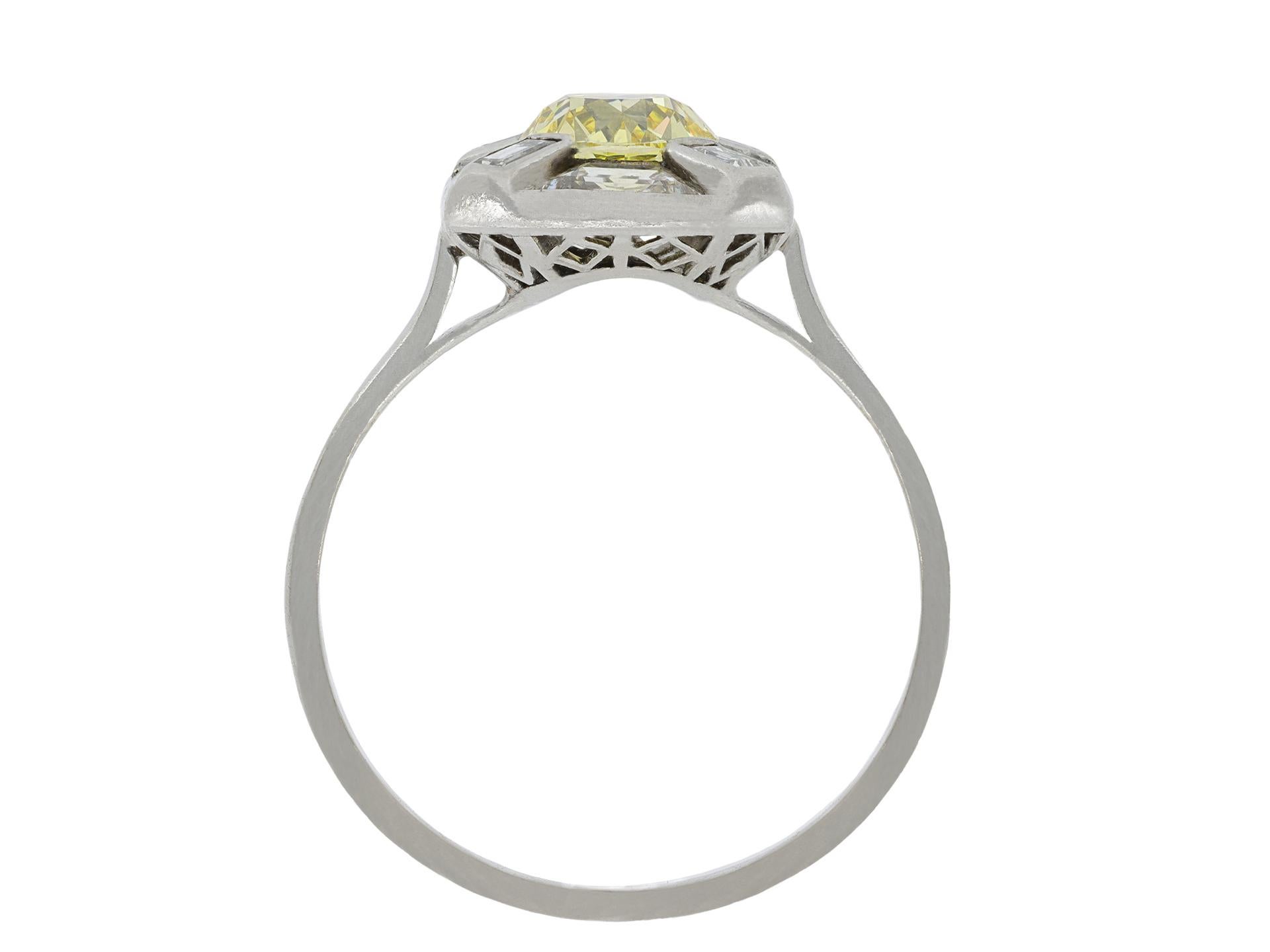 Fancy intense yellow diamond cluster ring. Set to centre with a cushion shape old mine natural fancy intense yellow diamond, IF clarity, with a weight of 1.24 carats, in an open back part rubover setting, adorned by four rectangular baguette cut