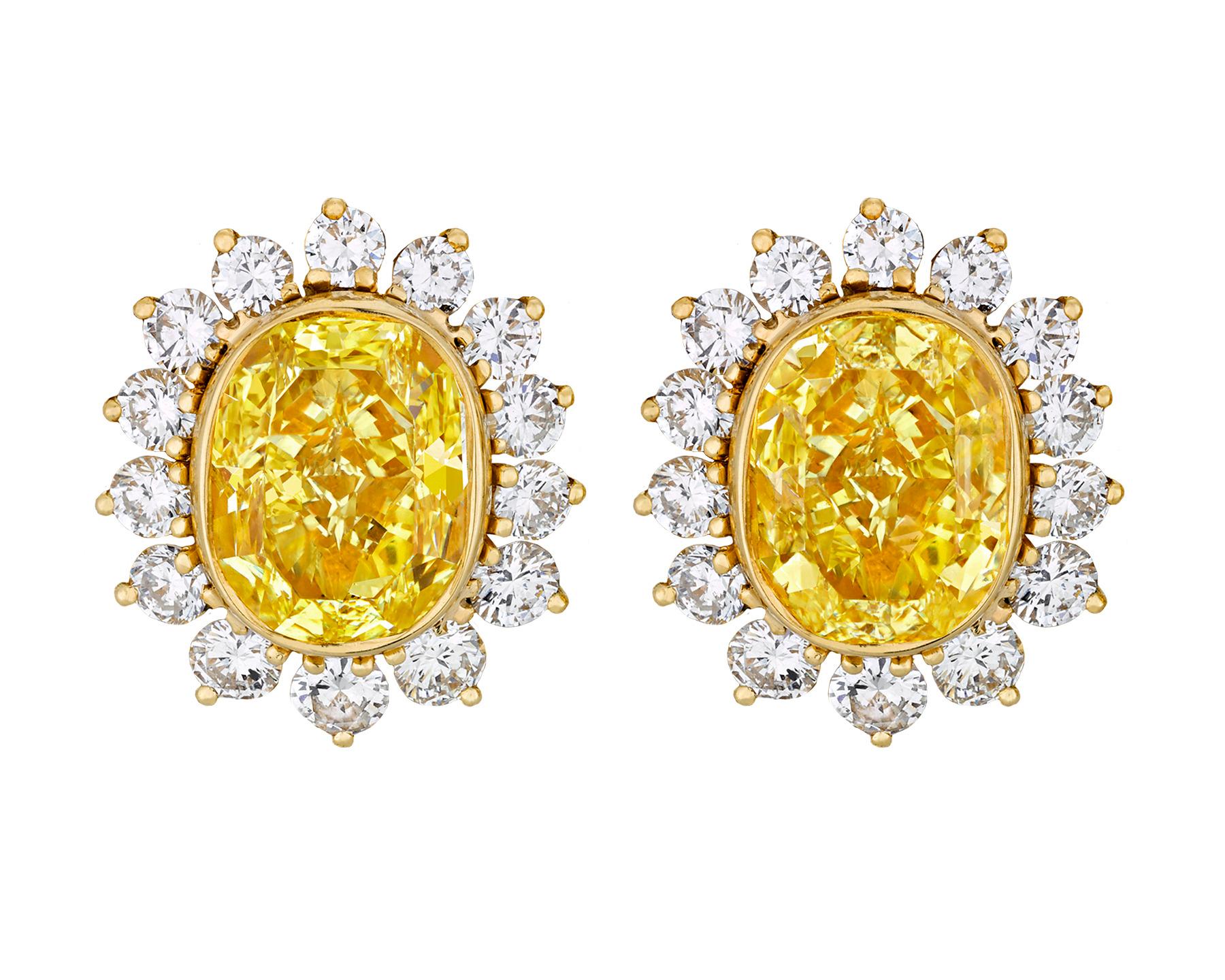 Two perfectly matched fancy intense yellow diamonds totaling 11.36 carats are at the center of these glamorous convertible earrings. Weighing 5.73 carats and 5.63 carats, the exceptionally rare gems possess the radiant, highly saturated lemon yellow