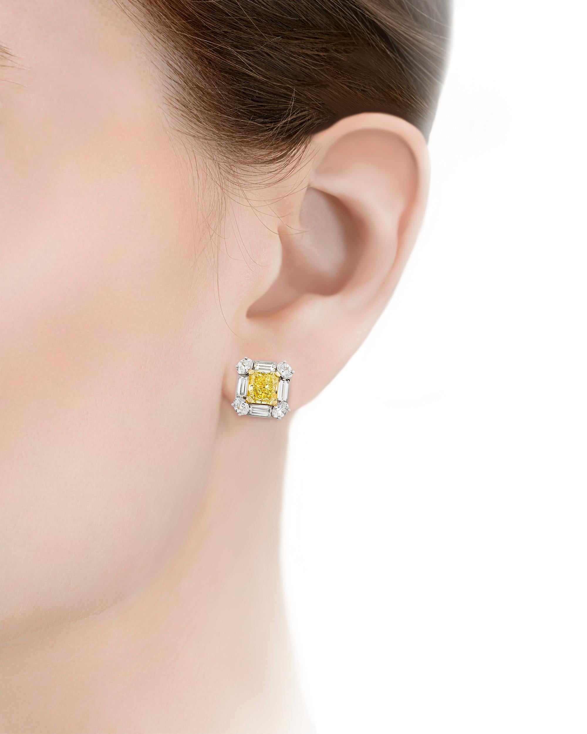 These fancy intense yellow diamond earrings reflect elegance at its most brilliant. Weighing 2.08 carats and 2.10 carats, the remarkably rare gems possess the radiant, highly saturated lemon yellow for which fancy intense yellow diamonds are