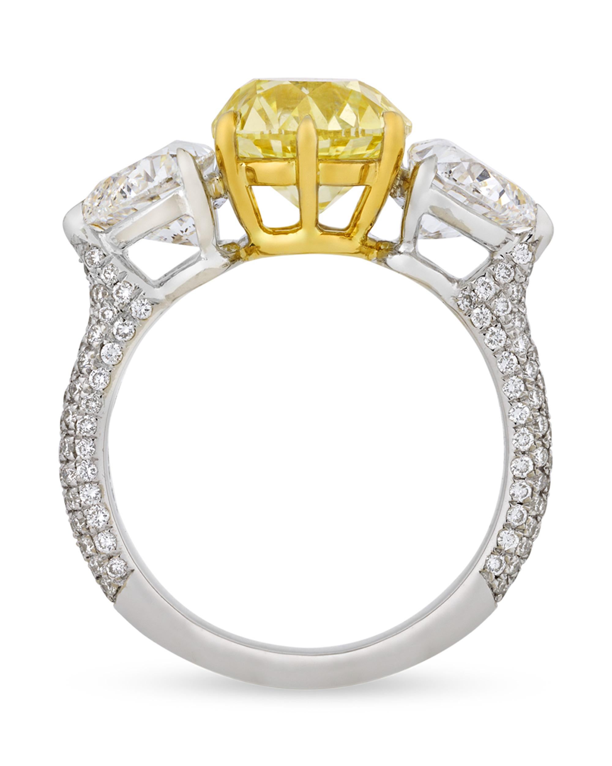 Featuring a captivating sunshiny hue, this ring showcases a glittering Old European-cut yellow diamond weighing 2.59 carats. The diamond is certified by the Gemological Institute of America as displaying VS1 clarity and possessing a coveted