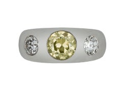 Fancy intense yellow diamond three stone gypsy ring, circa 1950.