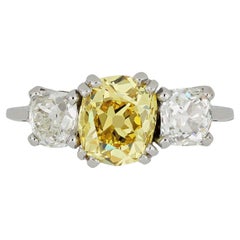 Antique Fancy intense yellow diamond three stone ring, circa 1920.