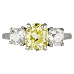 Fancy intense yellow diamond three stone ring, circa 1920.